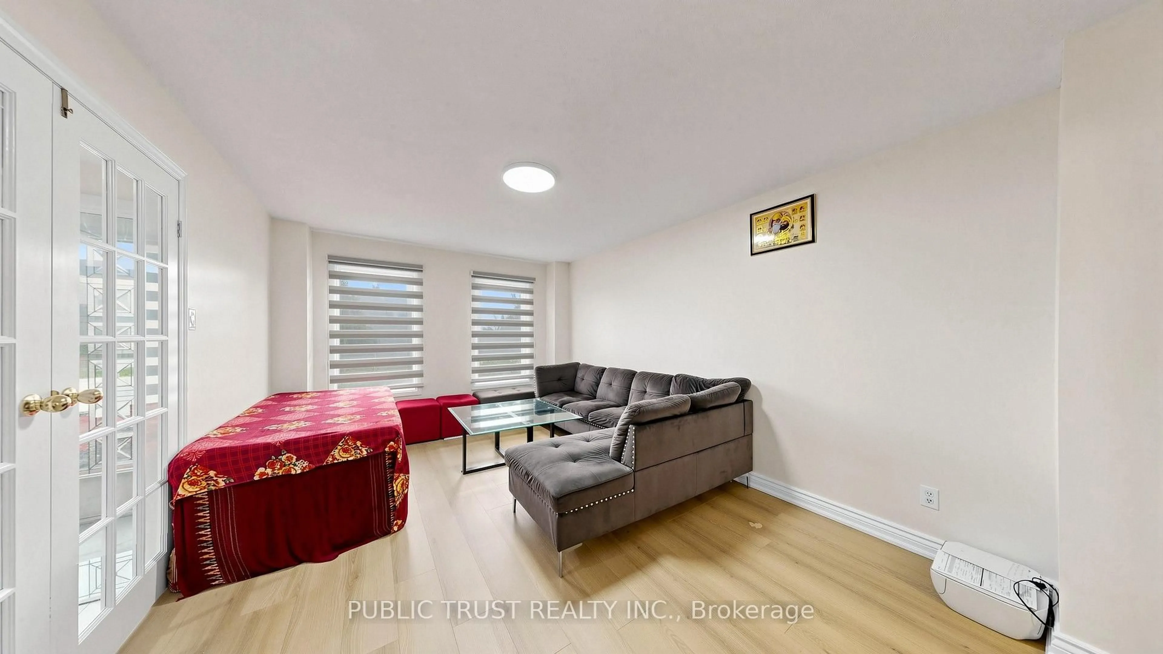 Living room with furniture, wood/laminate floor for 27 Mackay St, Brampton Ontario L6S 3P8