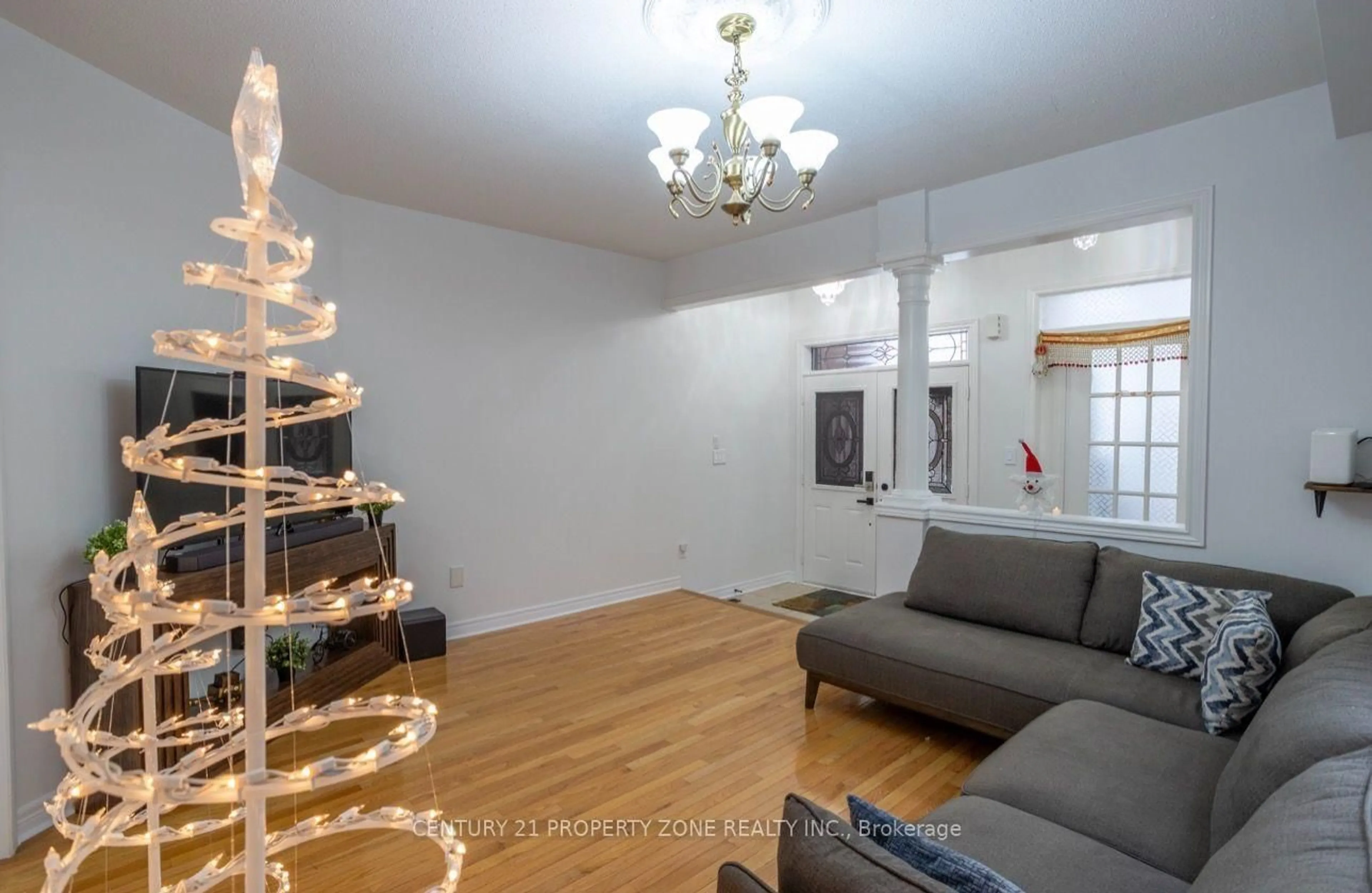 Living room with furniture, wood/laminate floor for 31 Game Creek Cres, Brampton Ontario L7A 0K3
