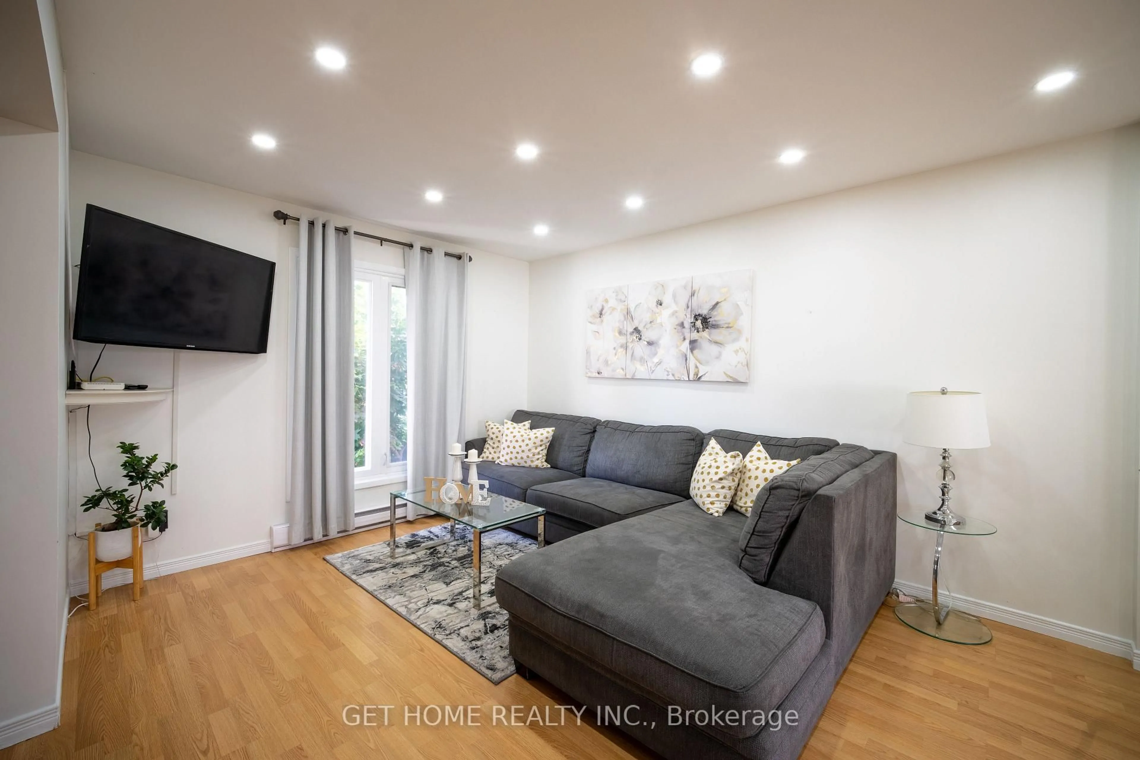 Living room with furniture, wood/laminate floor for 5 Huronia Crt, Brampton Ontario L6S 2C7