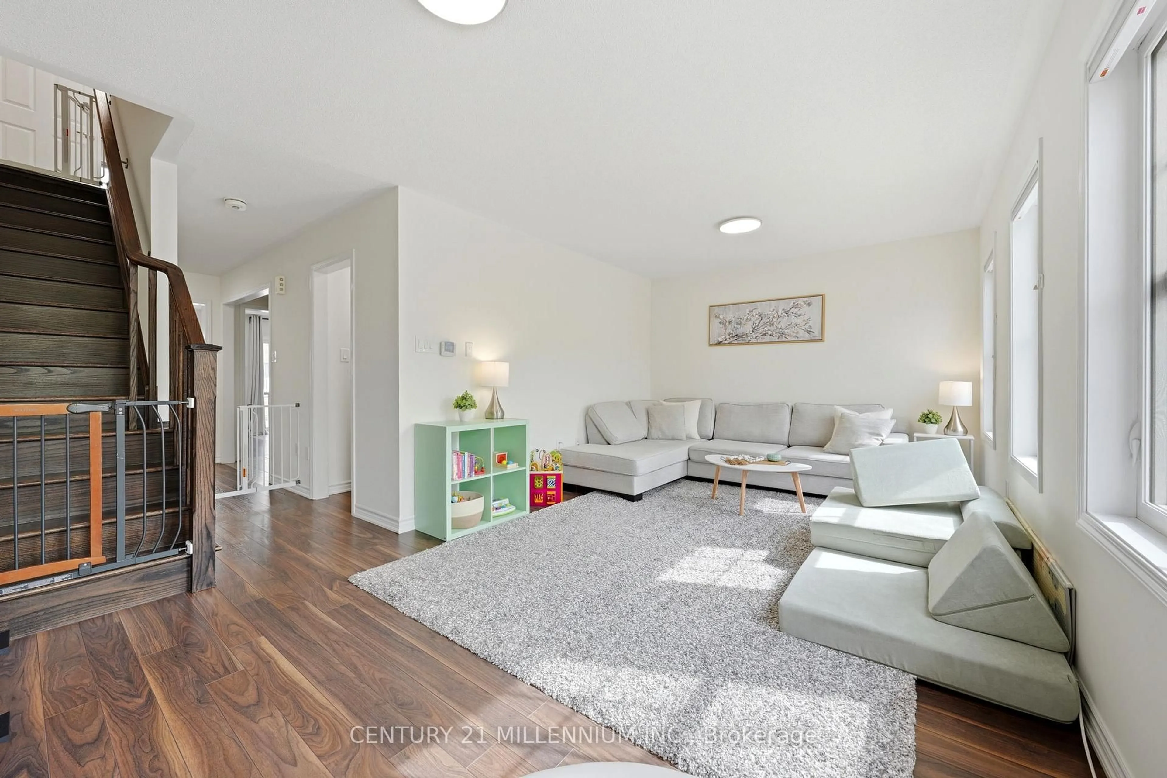 Living room with furniture, wood/laminate floor for 242 Remembrance Rd, Brampton Ontario L7A 4P4