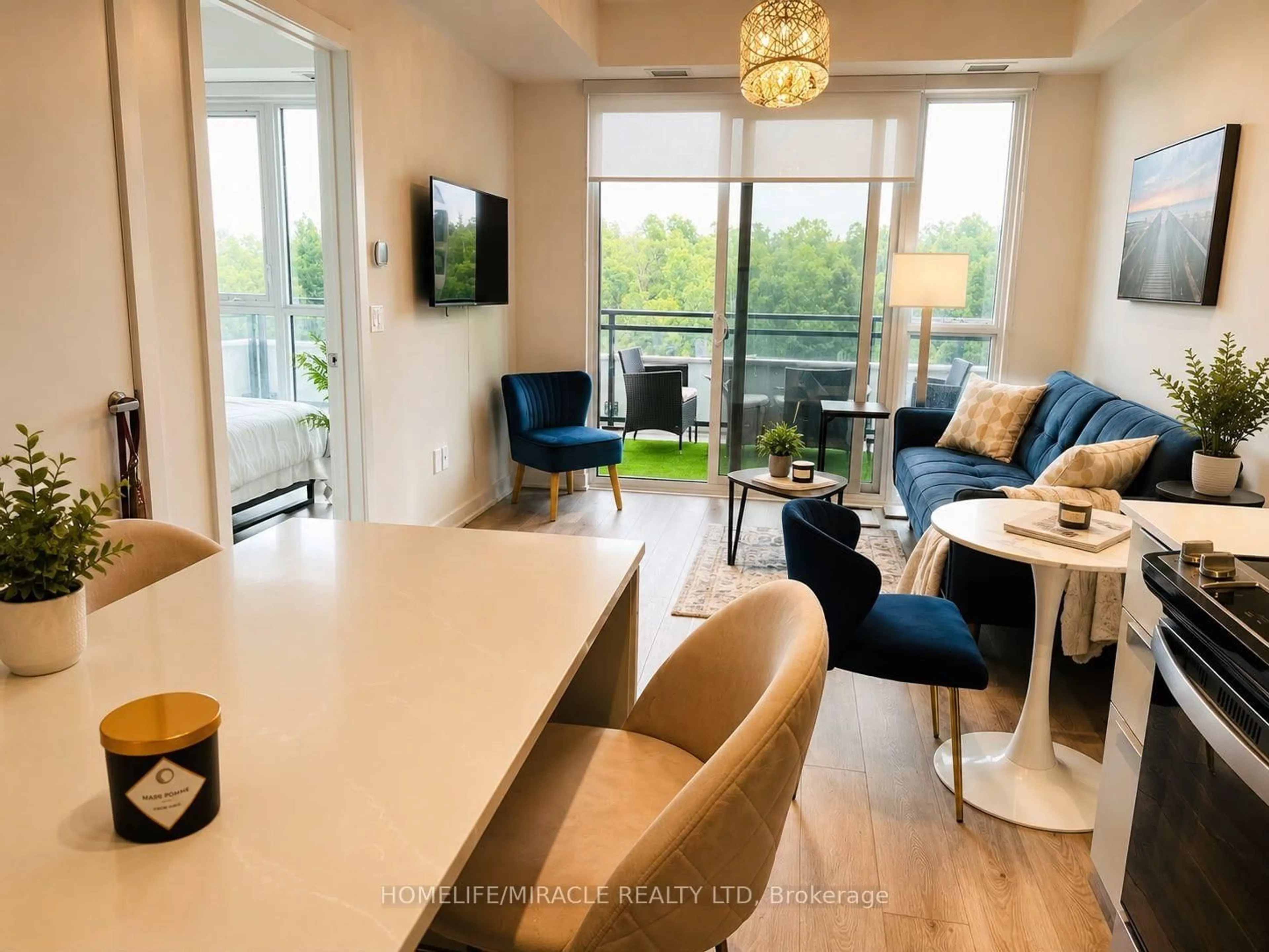 Living room with furniture, wood/laminate floor for 770 Whitlock Ave #408, Milton Ontario L9E 2B2