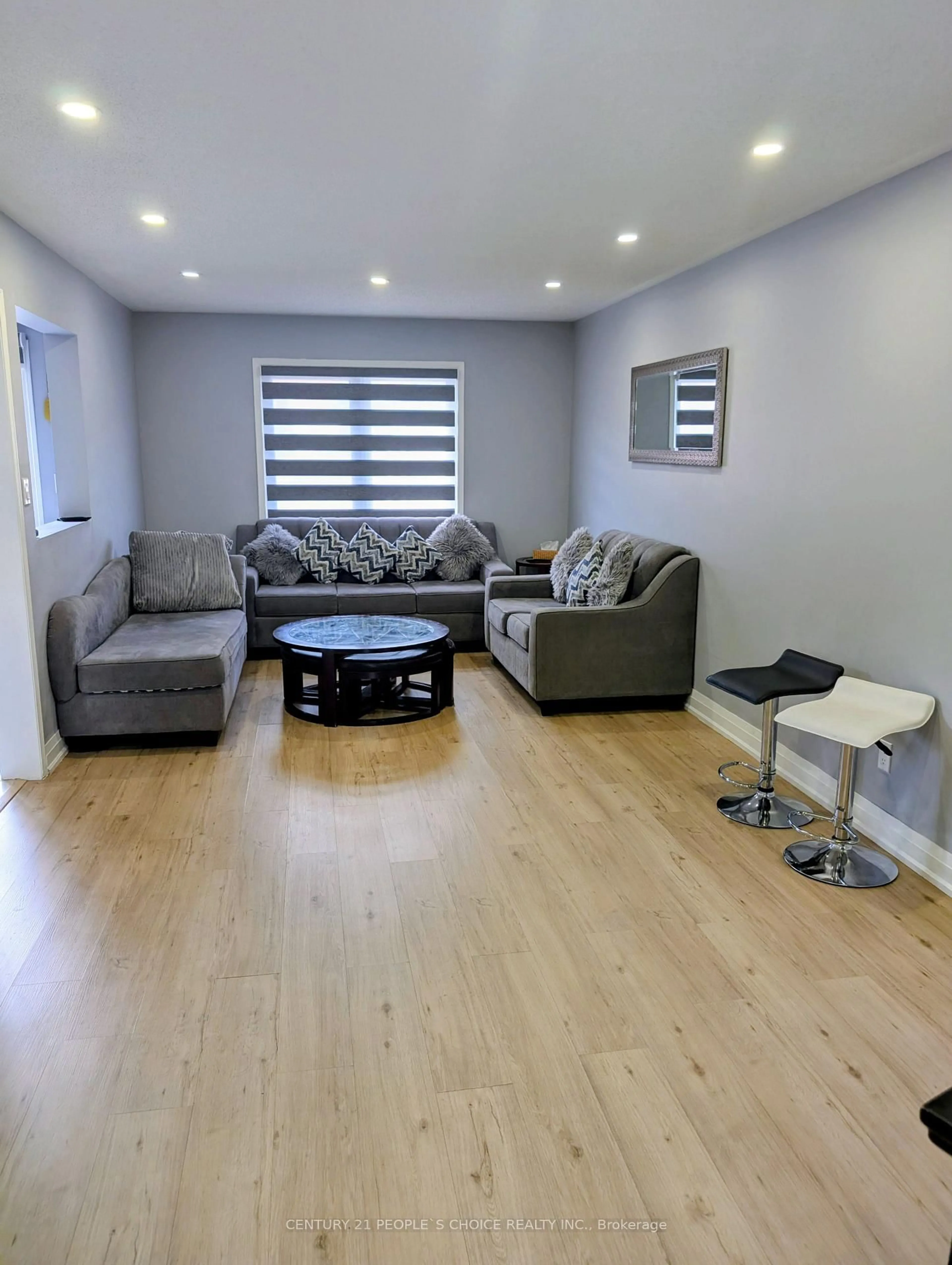 Living room with furniture, wood/laminate floor for 7 Amazon Crt, Brampton Ontario L6R 1C7