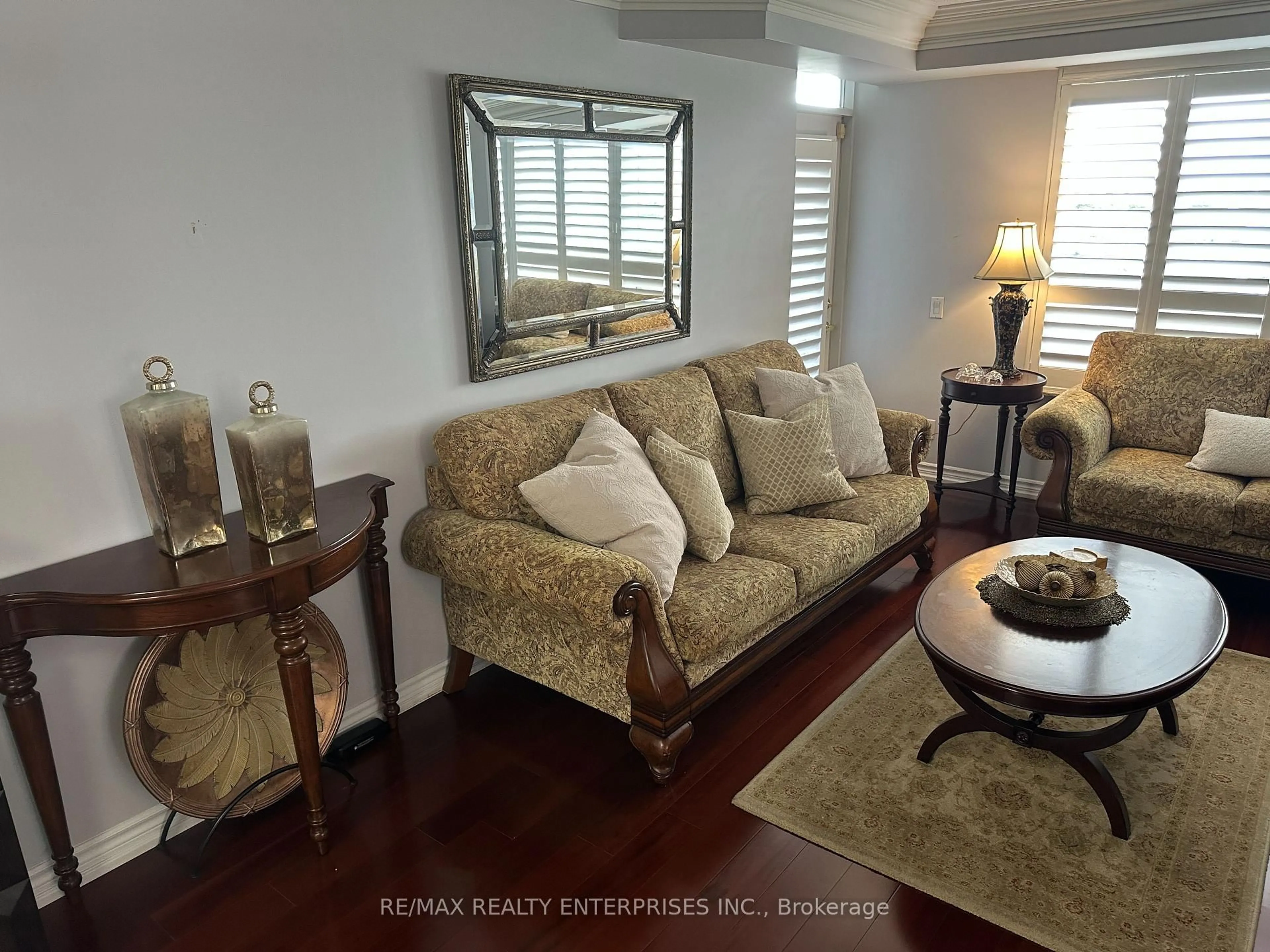 Living room with furniture, wood/laminate floor for 35 Kingsbridge Garden Circ #711, Mississauga Ontario L5R 3Z5