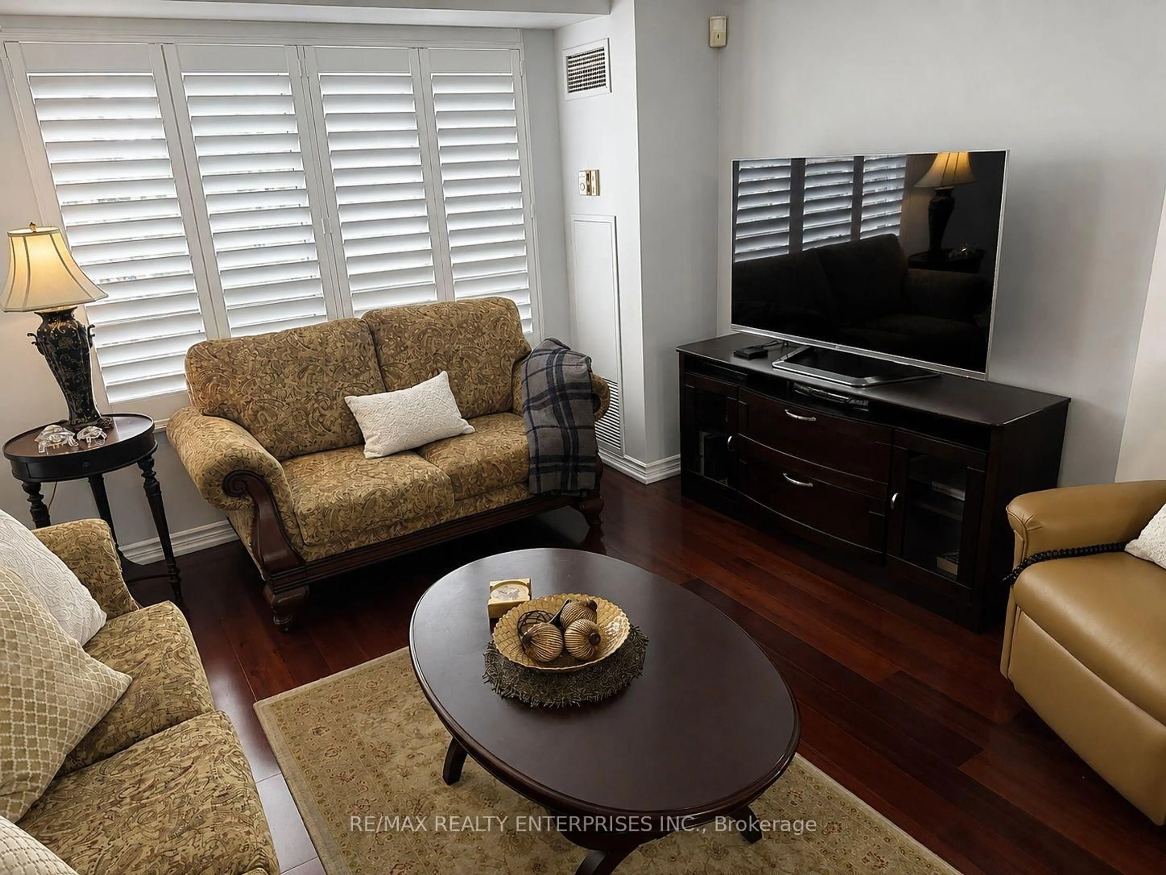 Living room with furniture, wood/laminate floor for 35 Kingsbridge Garden Circ #711, Mississauga Ontario L5R 3Z5