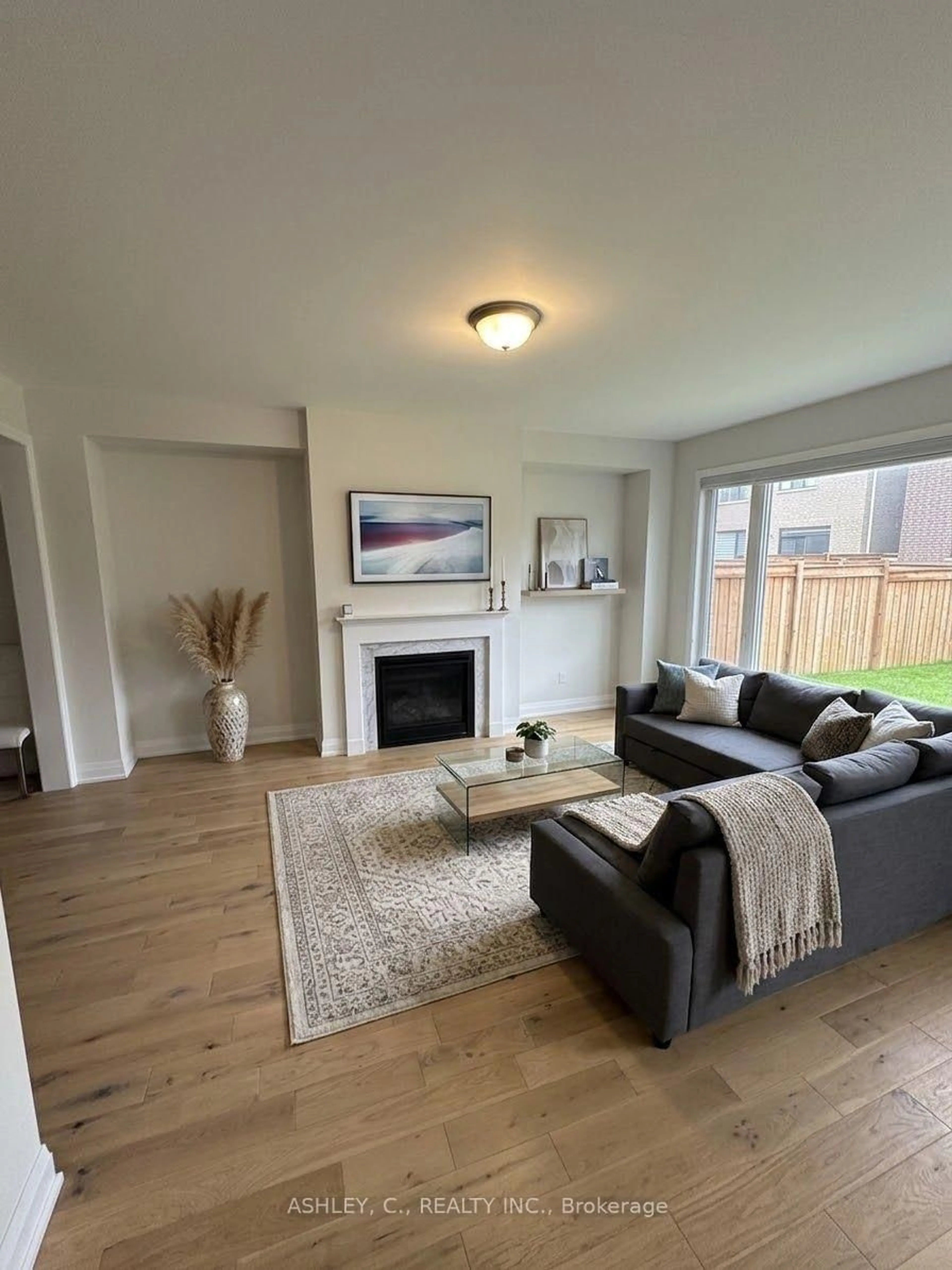 Living room with furniture, wood/laminate floor for 25 Gladmary Dr, Brampton Ontario L6Y 6K9