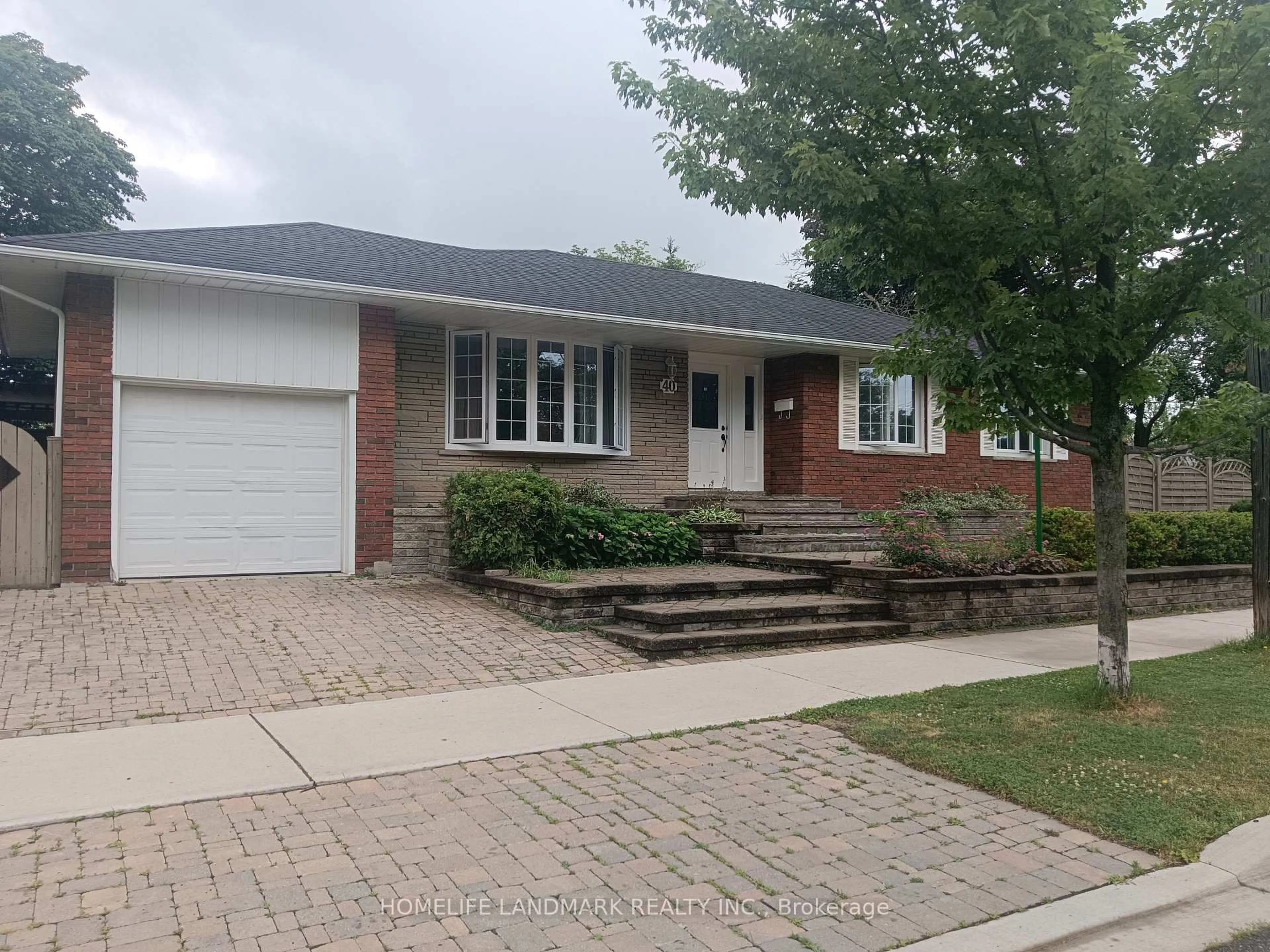 Home with brick exterior material, street for 40 Carsbrooke Rd, Toronto Ontario M9C 3C1