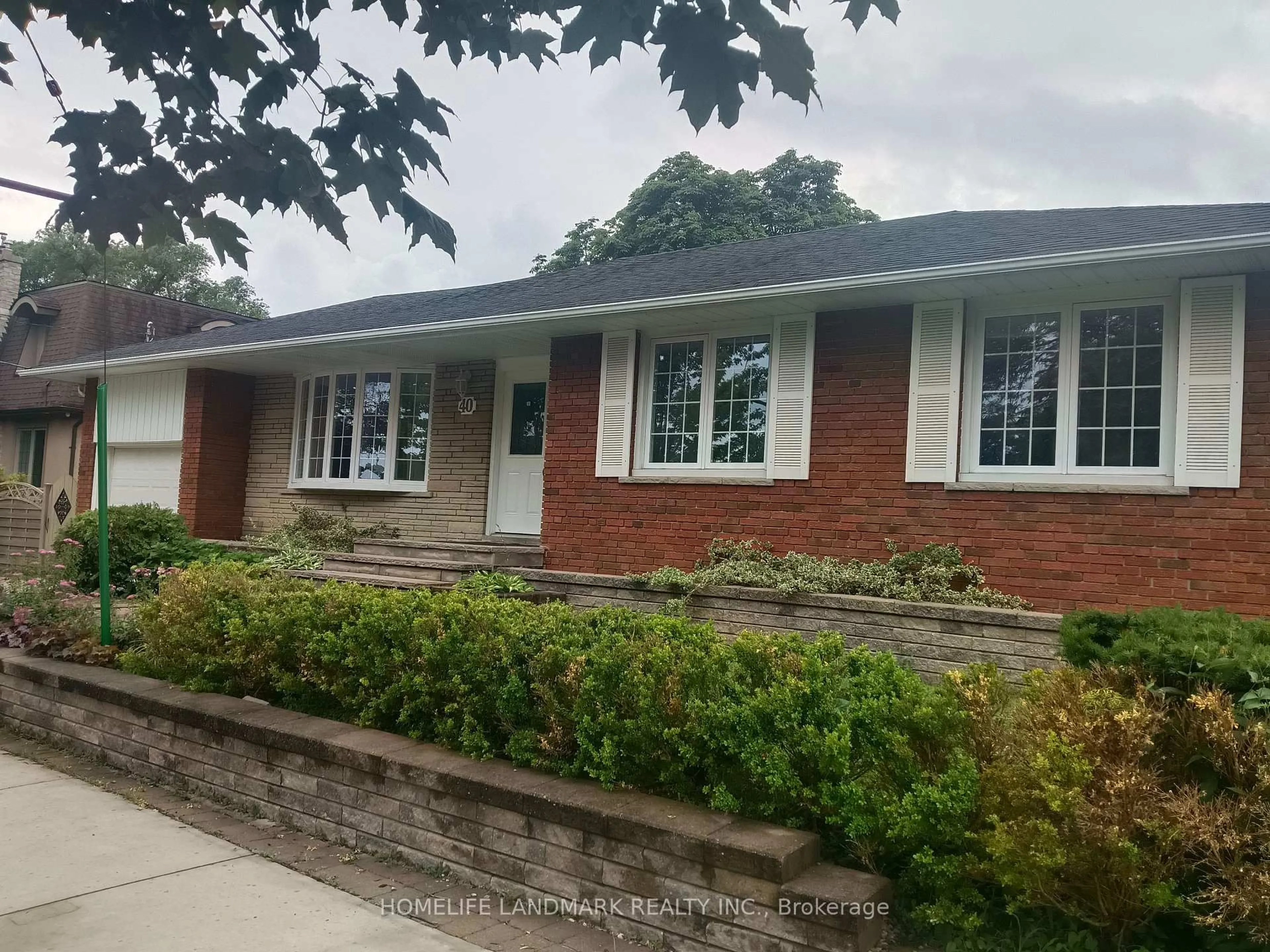 Home with brick exterior material, street for 40 Carsbrooke Rd, Toronto Ontario M9C 3C1