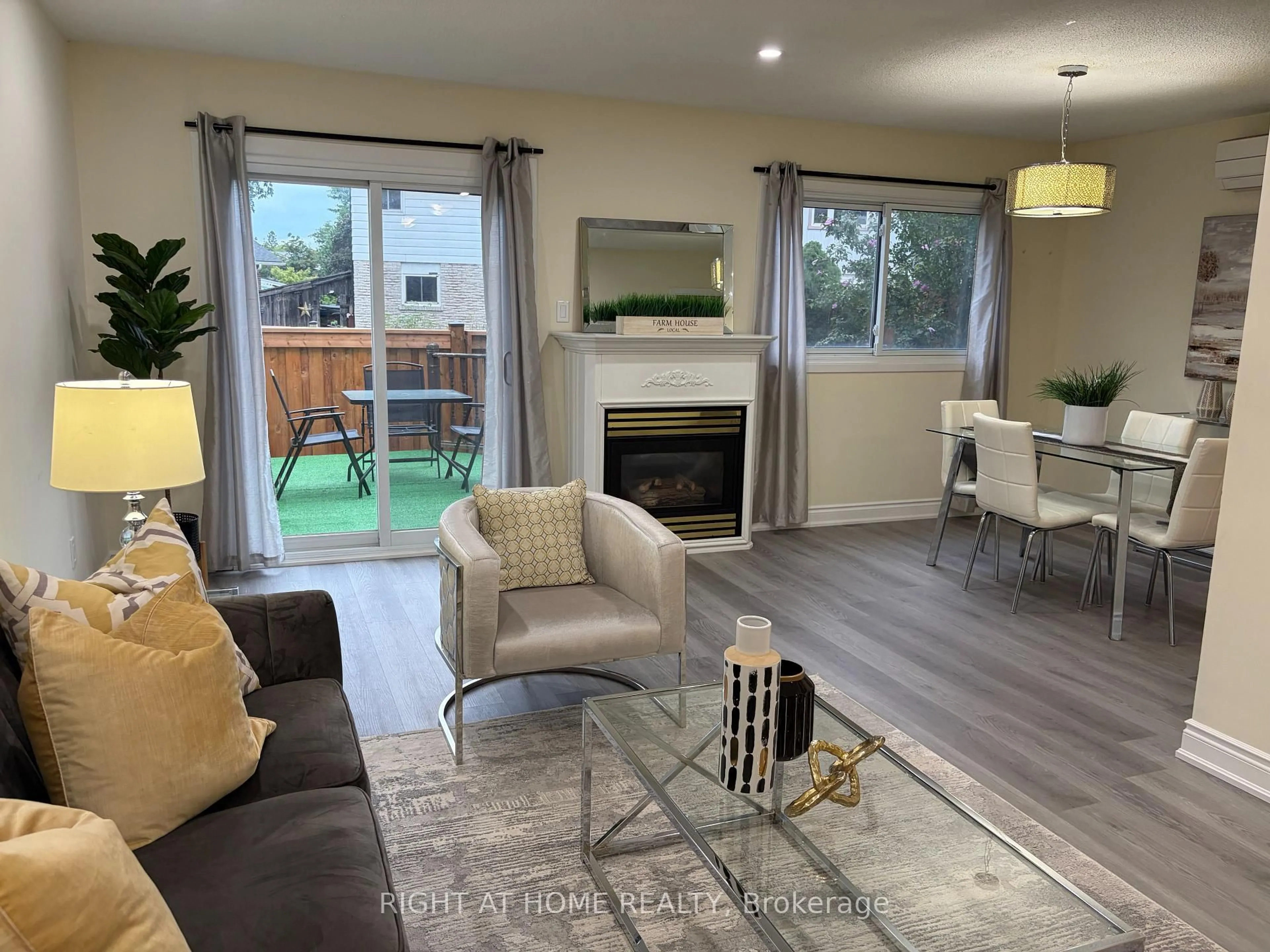 Living room with furniture, wood/laminate floor for 5021 Pinedale Ave #5, Burlington Ontario L7L 5J6