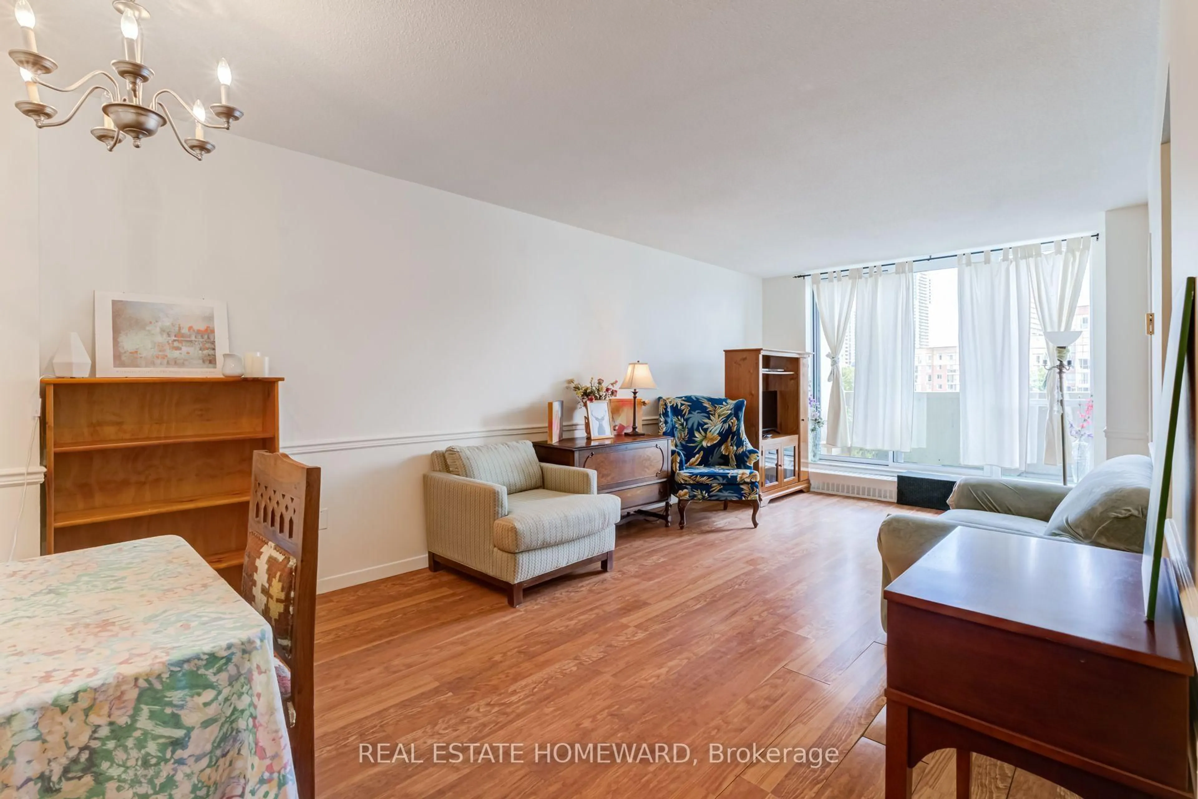 Living room with furniture, wood/laminate floor for 60 Southport St #218, Toronto Ontario M6S 3N4