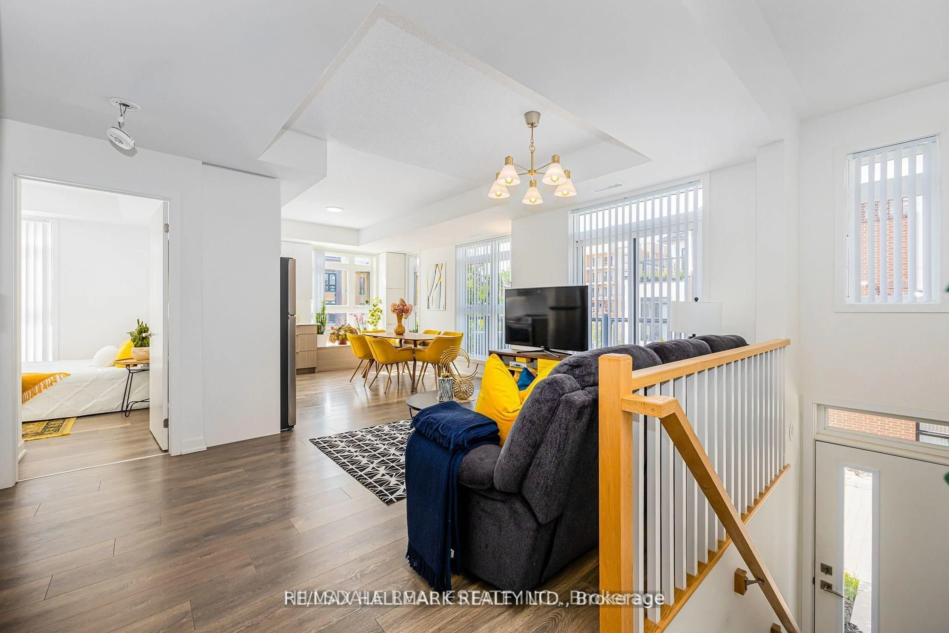 Living room with furniture, wood/laminate floor for 90 Canon Jackson Dr #207, Toronto Ontario M6M 0C1