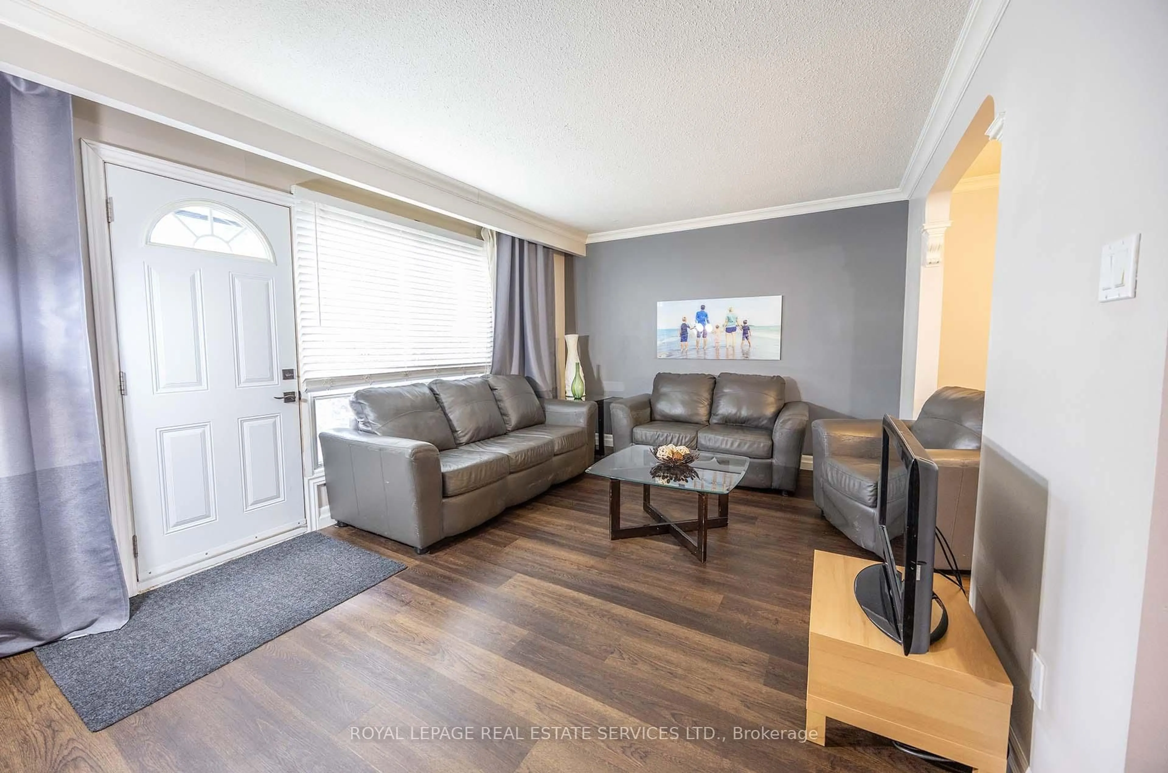 Living room with furniture, wood/laminate floor for 71 Old Burnhamthorpe Rd #18, Toronto Ontario M9C 3J6