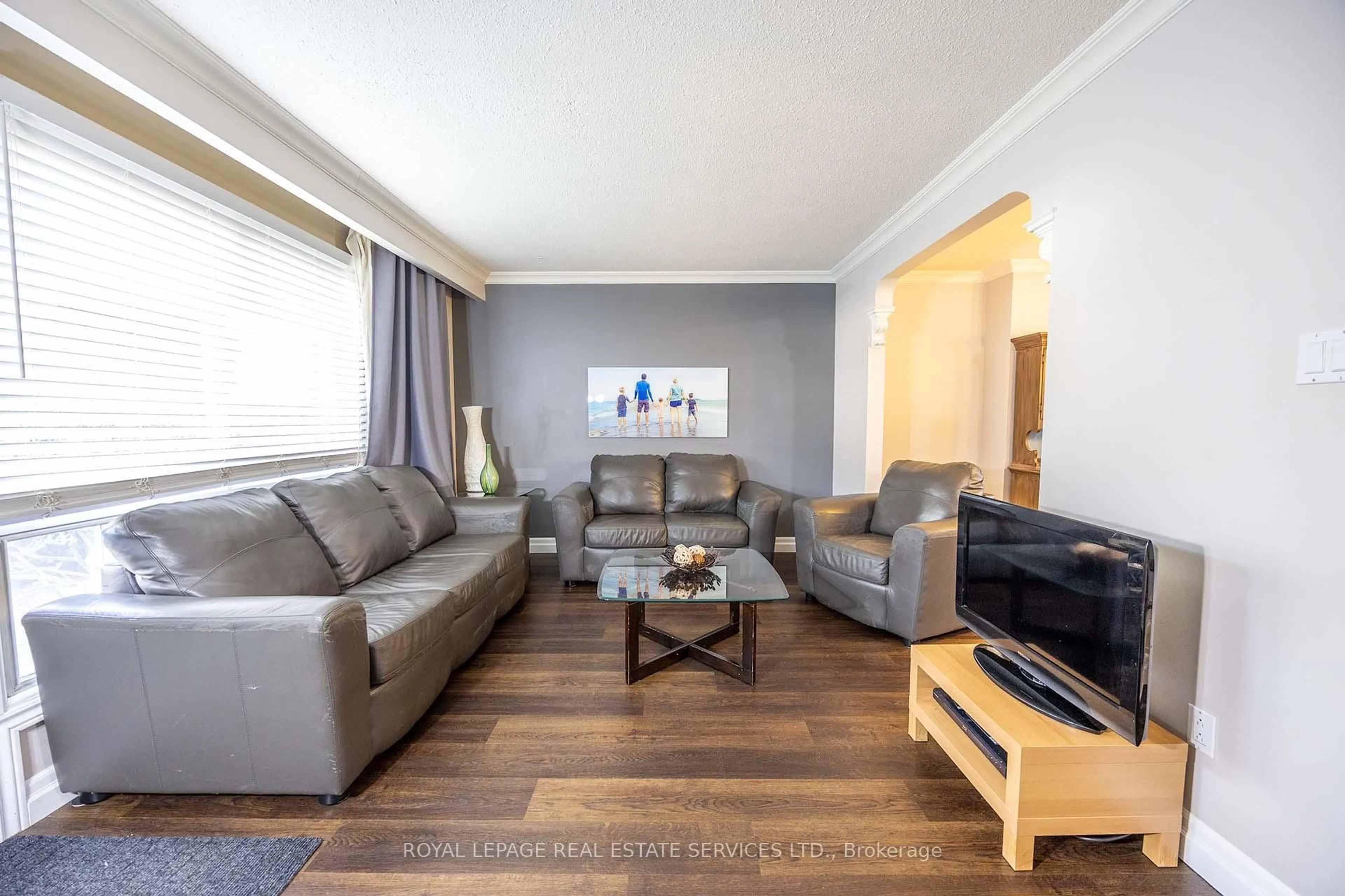 Living room with furniture, wood/laminate floor for 71 Old Burnhamthorpe Rd #18, Toronto Ontario M9C 3J6
