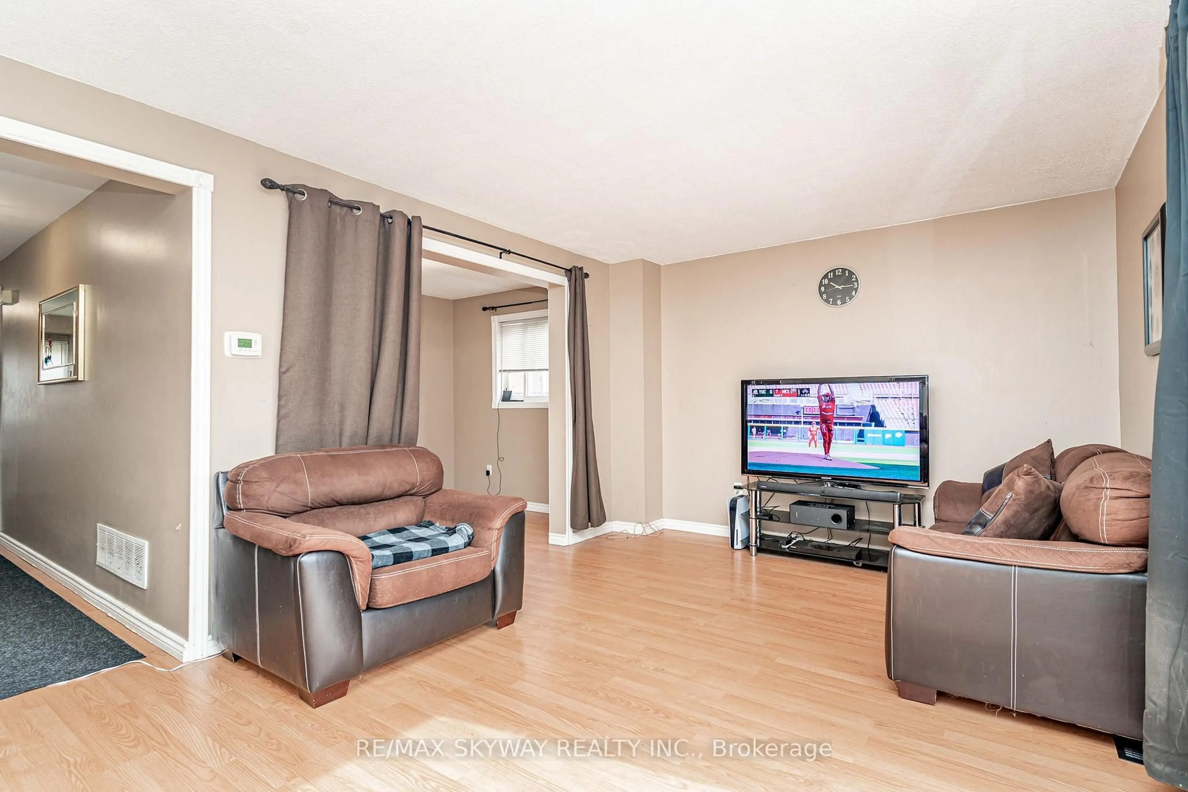 Living room with furniture, wood/laminate floor for 59 Skegby Rd, Brampton Ontario L6V 2T8