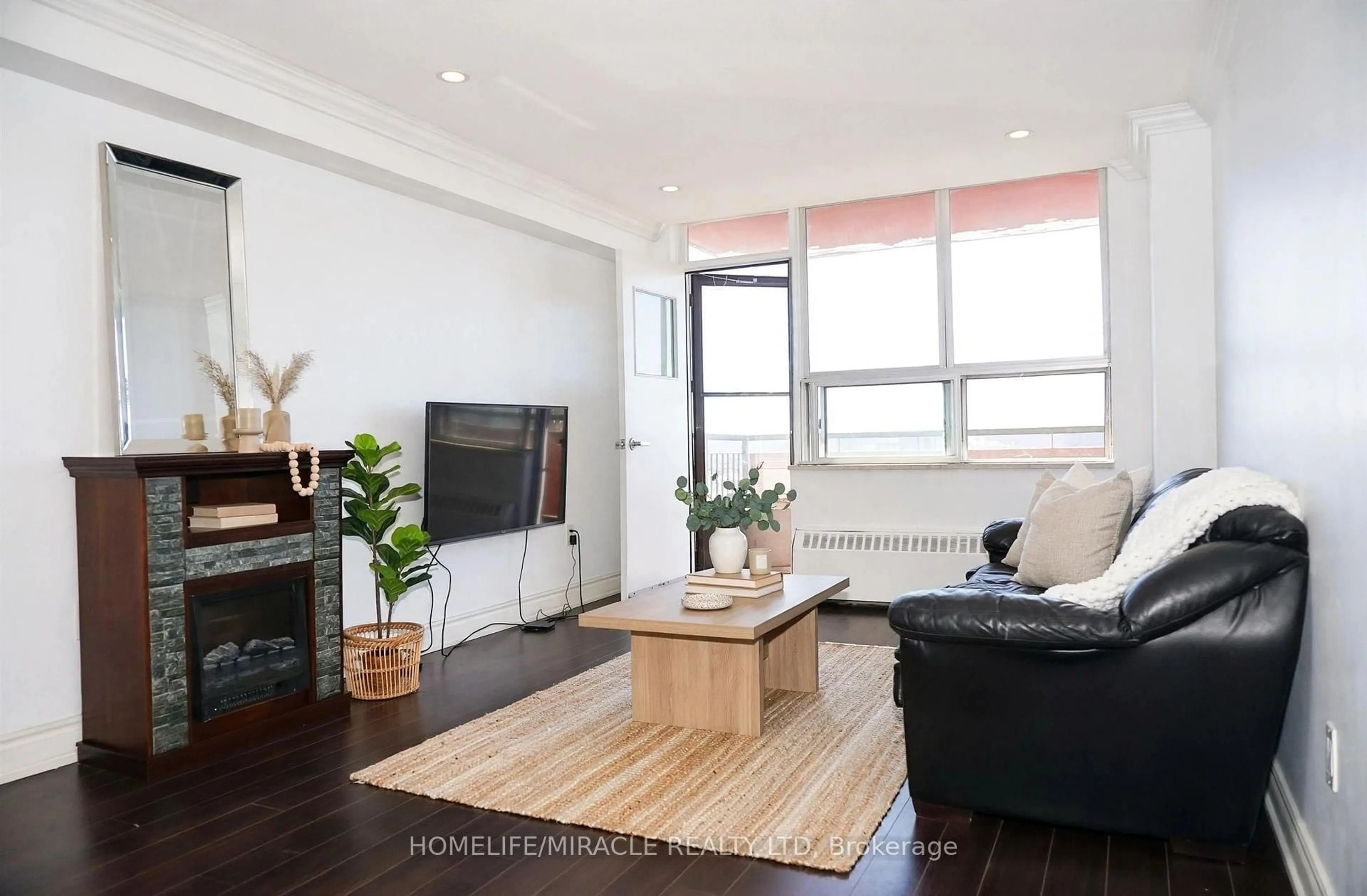 Living room with furniture, wood/laminate floor for 100 Lotherton Ptwy #605, Toronto Ontario M6B 2G8