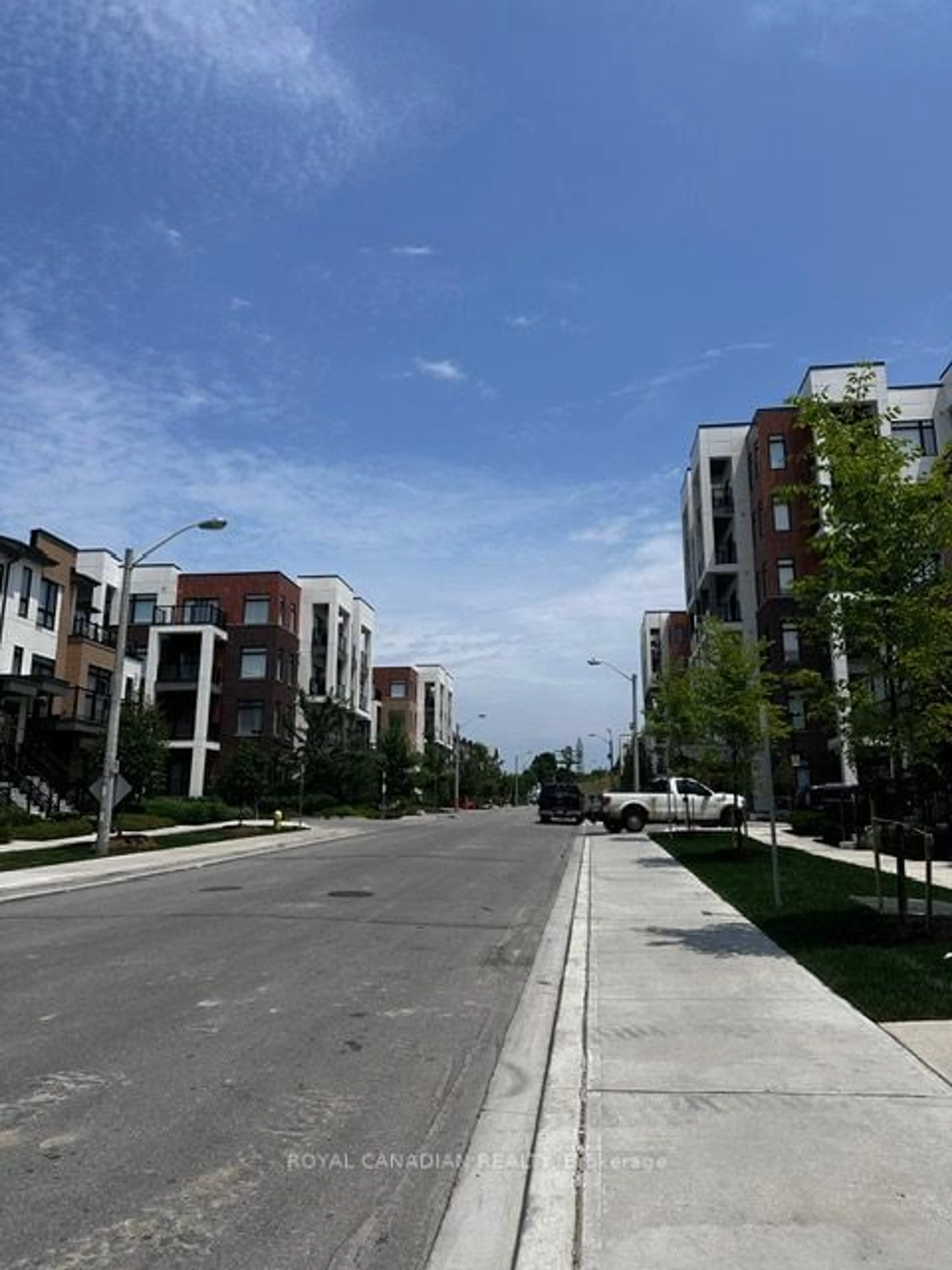 A view of a street for 165 Canon Jackson Dr #204, Toronto Ontario M6M 2G1