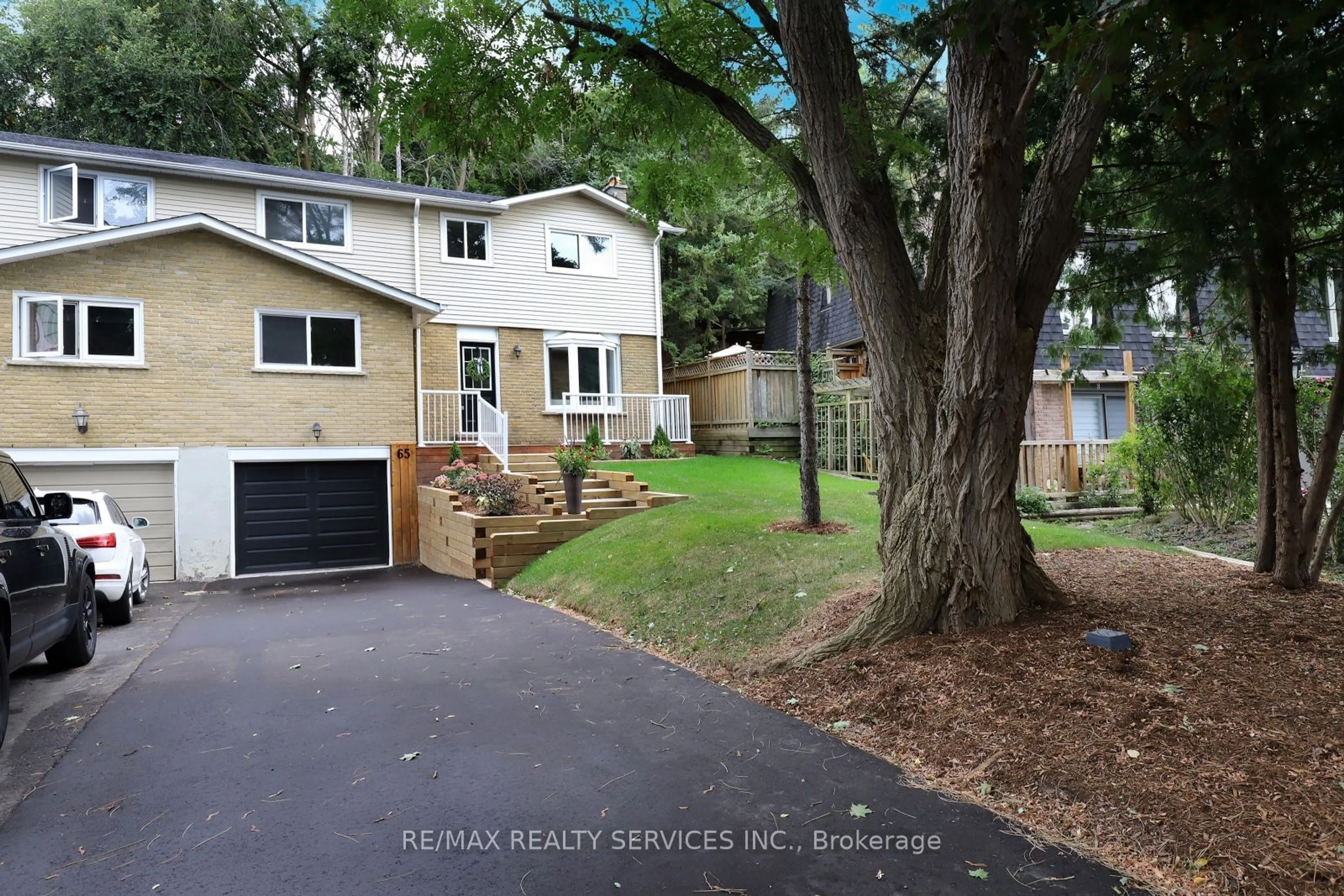 Frontside or backside of a home, the fenced backyard for 65 Hesp Dr, Caledon Ontario L7E 2R2