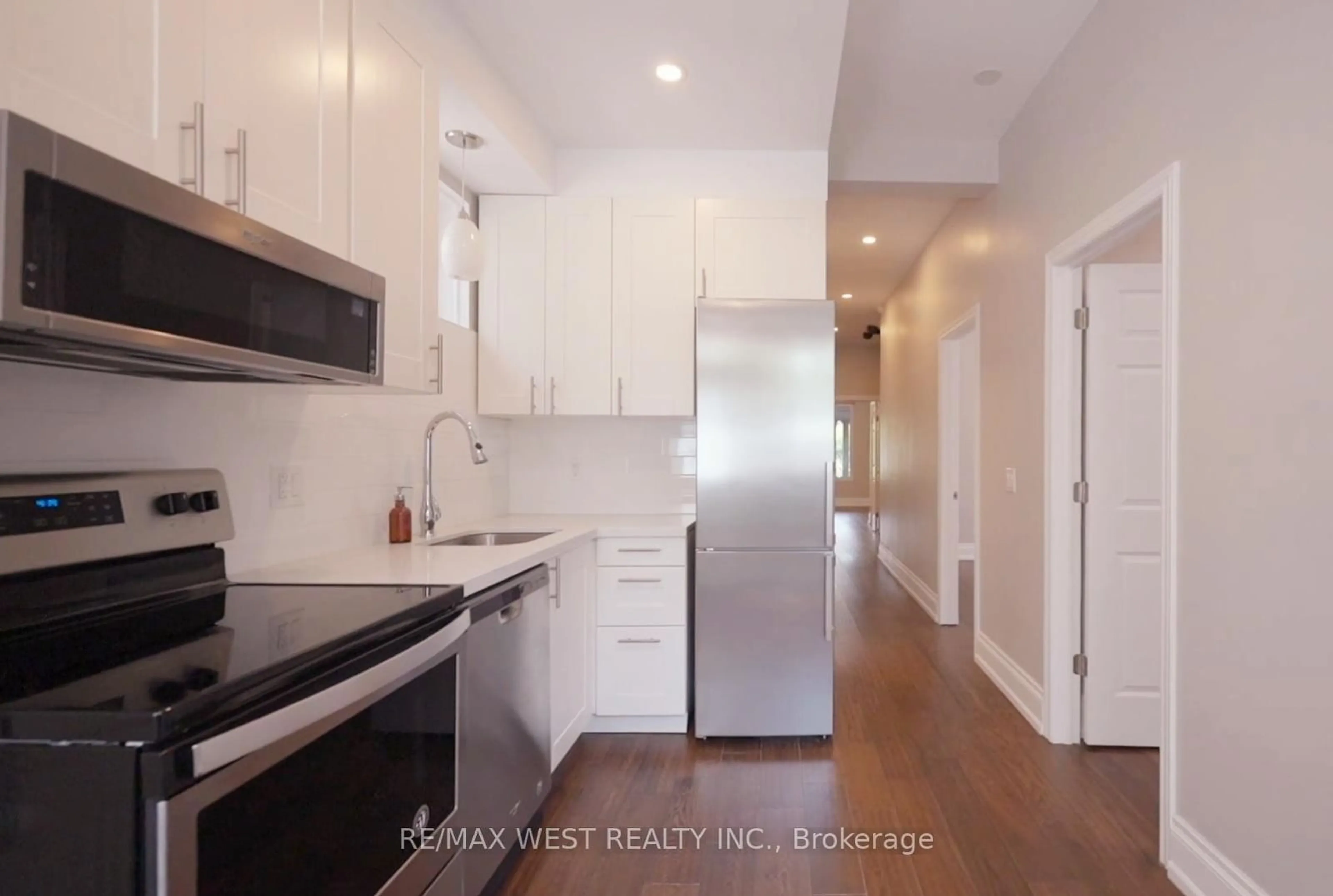 Kitchen with laundary machines, wood floors for 164 Dunn Ave, Toronto Ontario M6K 2R6