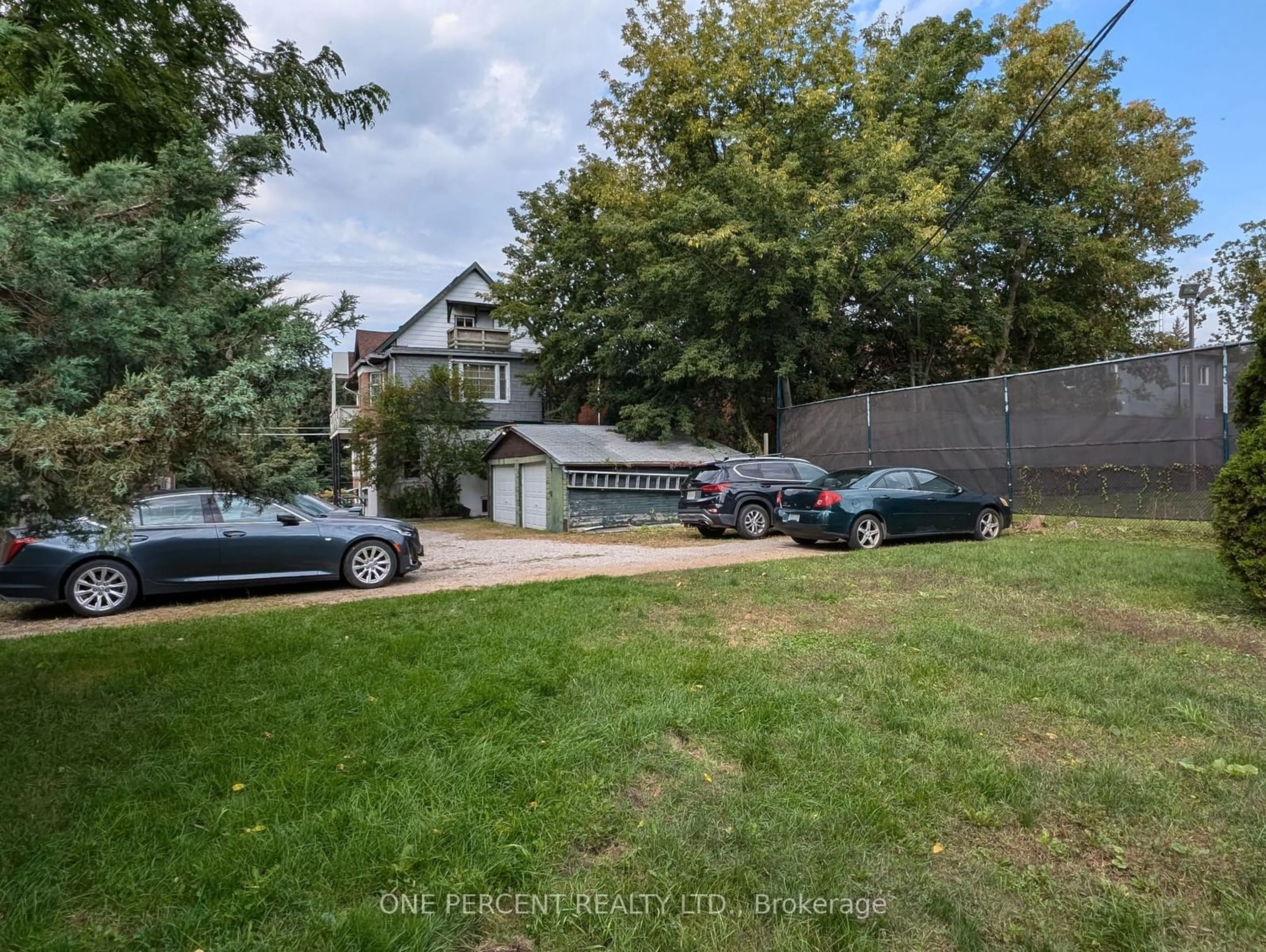 Frontside or backside of a home, the fenced backyard for 115 Parkside Dr, Toronto Ontario M6R 2Y8