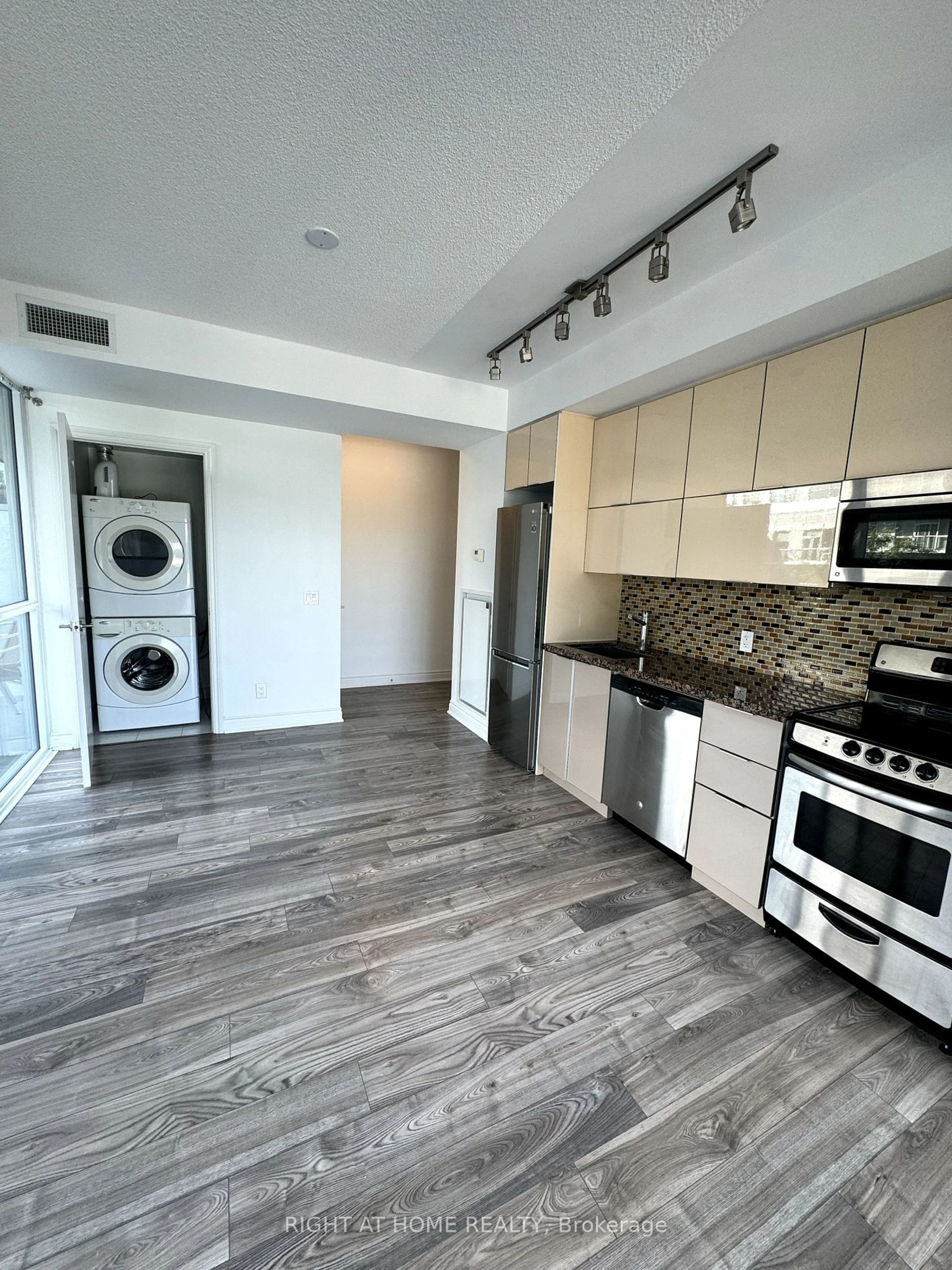 Kitchen with laundary machines, wood floors for 80 Marine Parade Dr #331, Toronto Ontario M8V 0A3