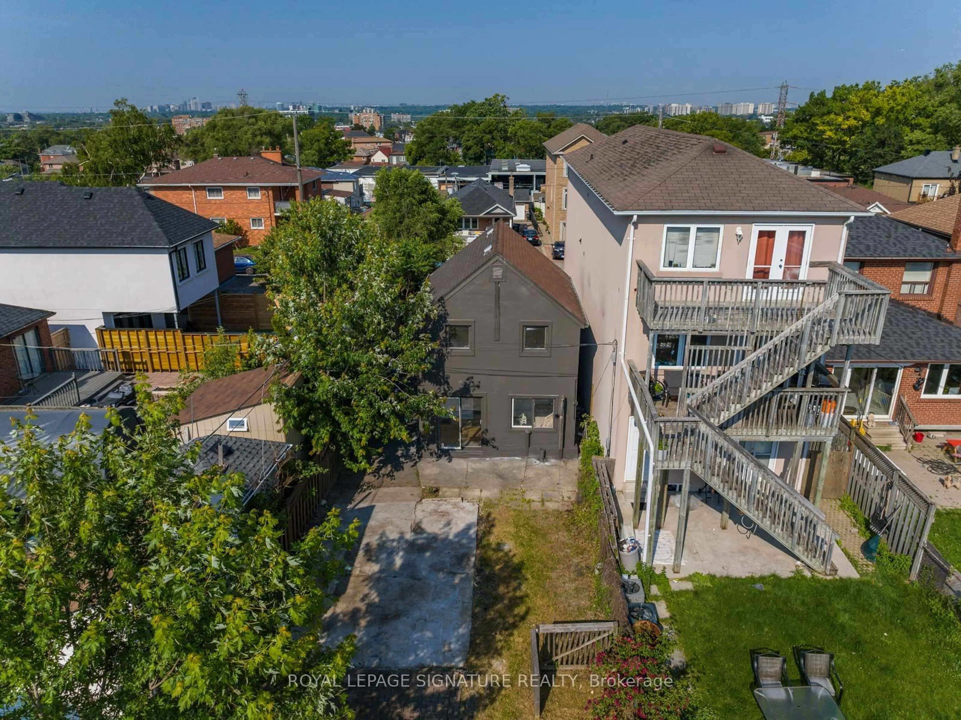 Frontside or backside of a home, the fenced backyard for 323 Gilbert Ave, Toronto Ontario M6E 4W9