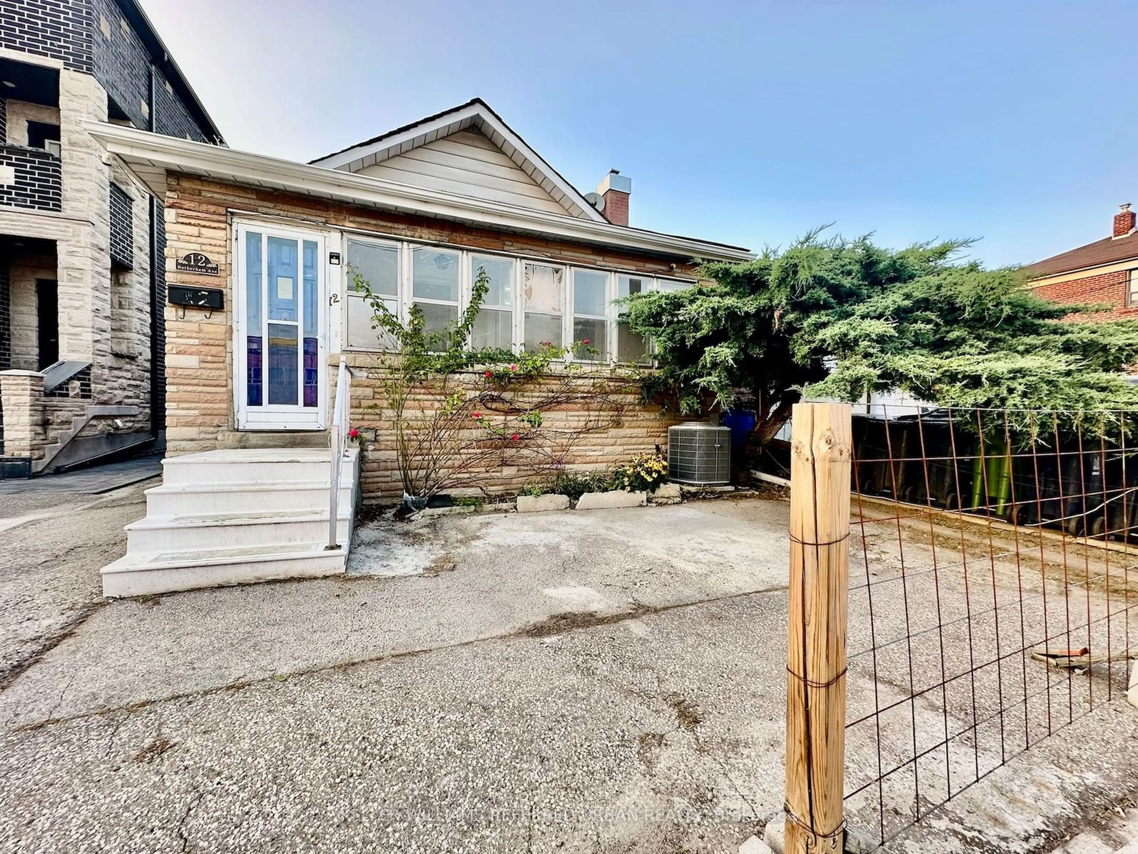 Frontside or backside of a home, the fenced backyard for 12 Rotherham Ave, Toronto Ontario M6M 1L8