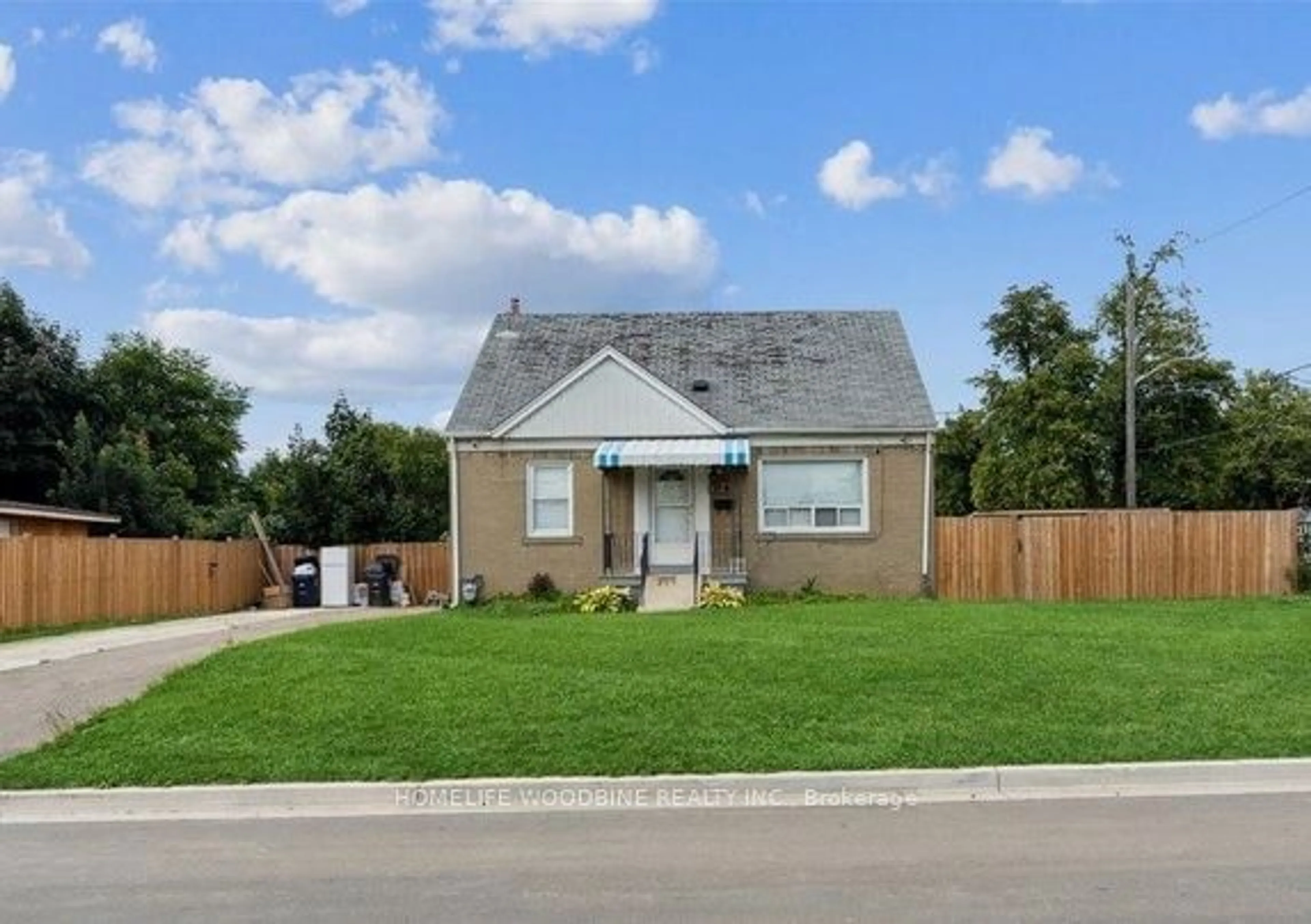 Frontside or backside of a home, the fenced backyard for 14 Kirby Rd, Toronto Ontario M3L 1B6