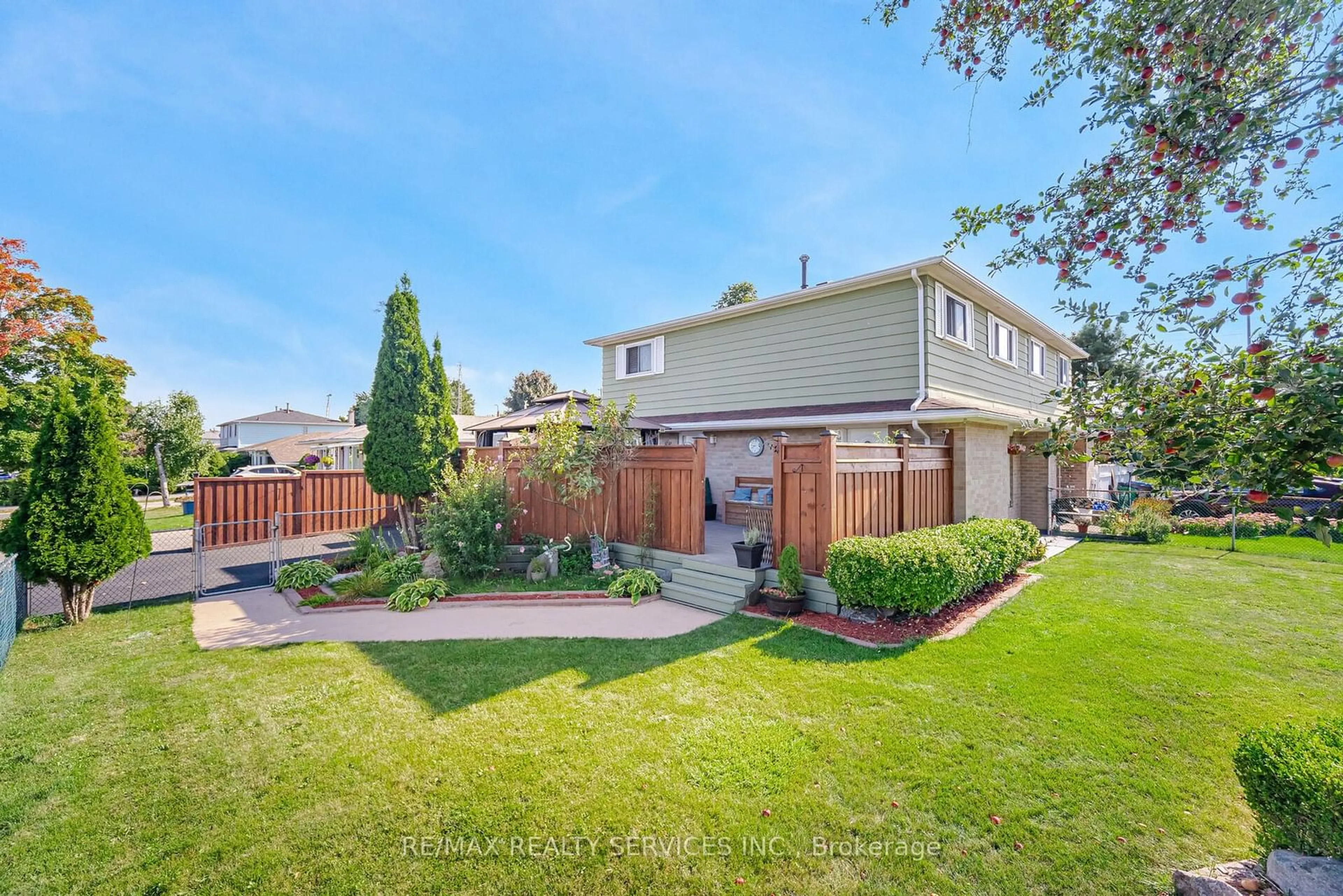 A pic from exterior of the house or condo, the fenced backyard for 97 Juniper Cres, Brampton Ontario L6S 1J9