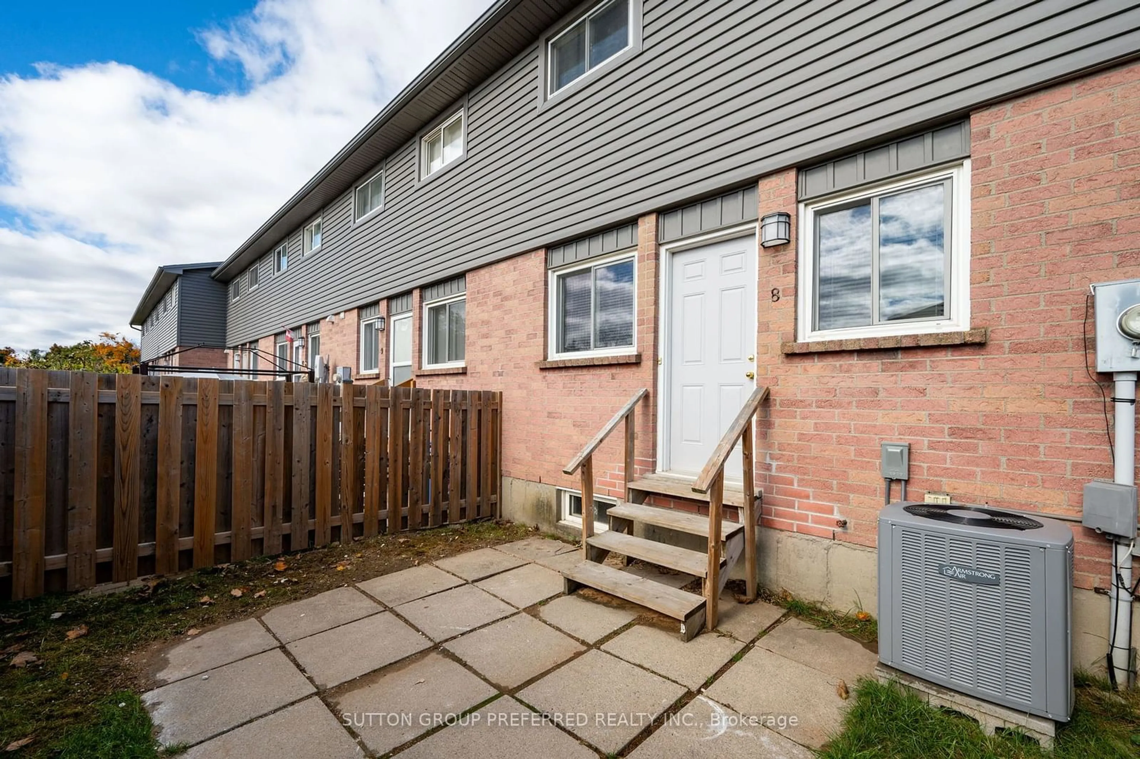 A pic from exterior of the house or condo, the fenced backyard for 1443 Huron St #8, London Ontario N5V 2E6