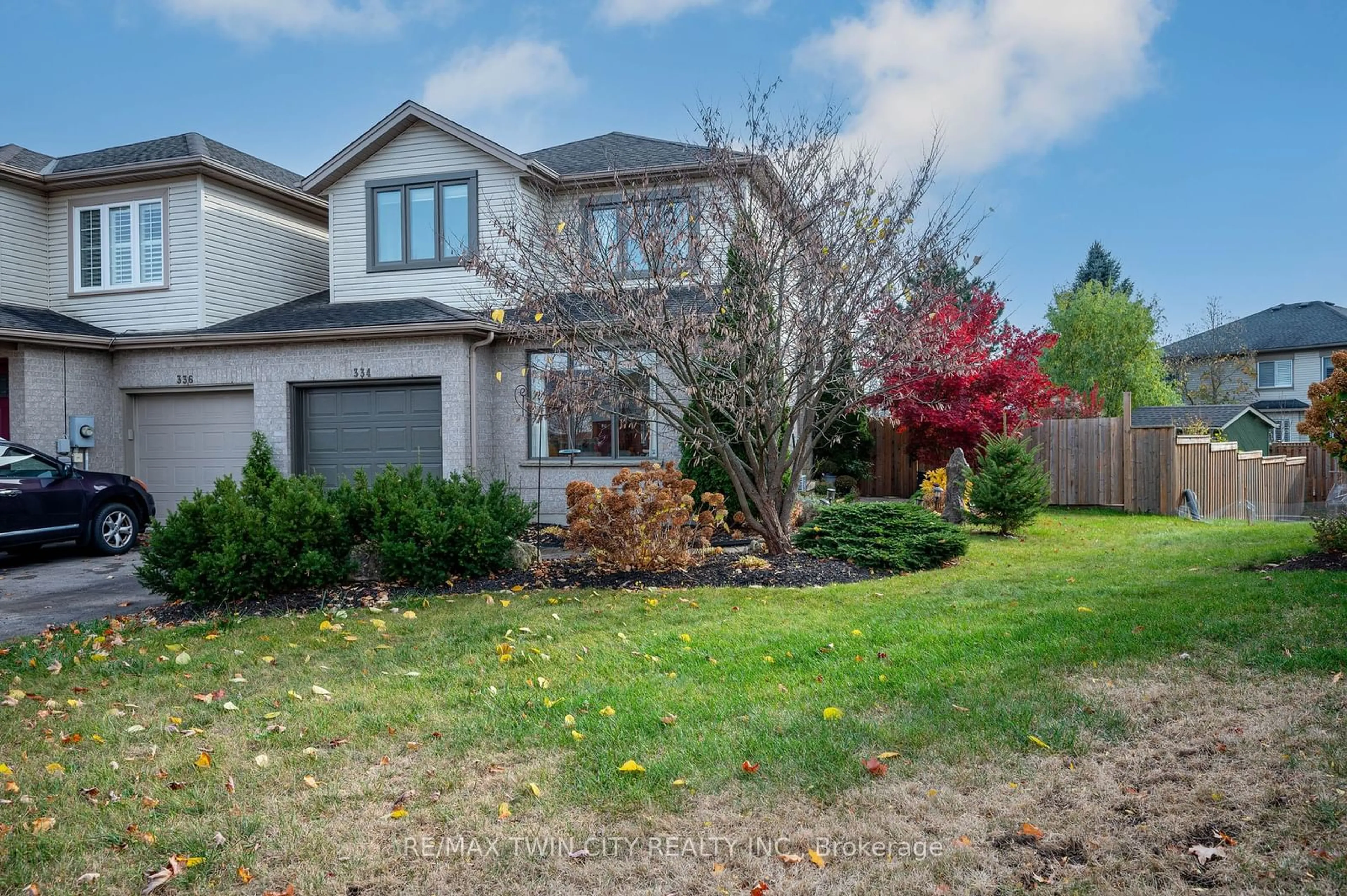 Frontside or backside of a home, the fenced backyard for 334 University Downs Cres, Waterloo Ontario N2K 4A9