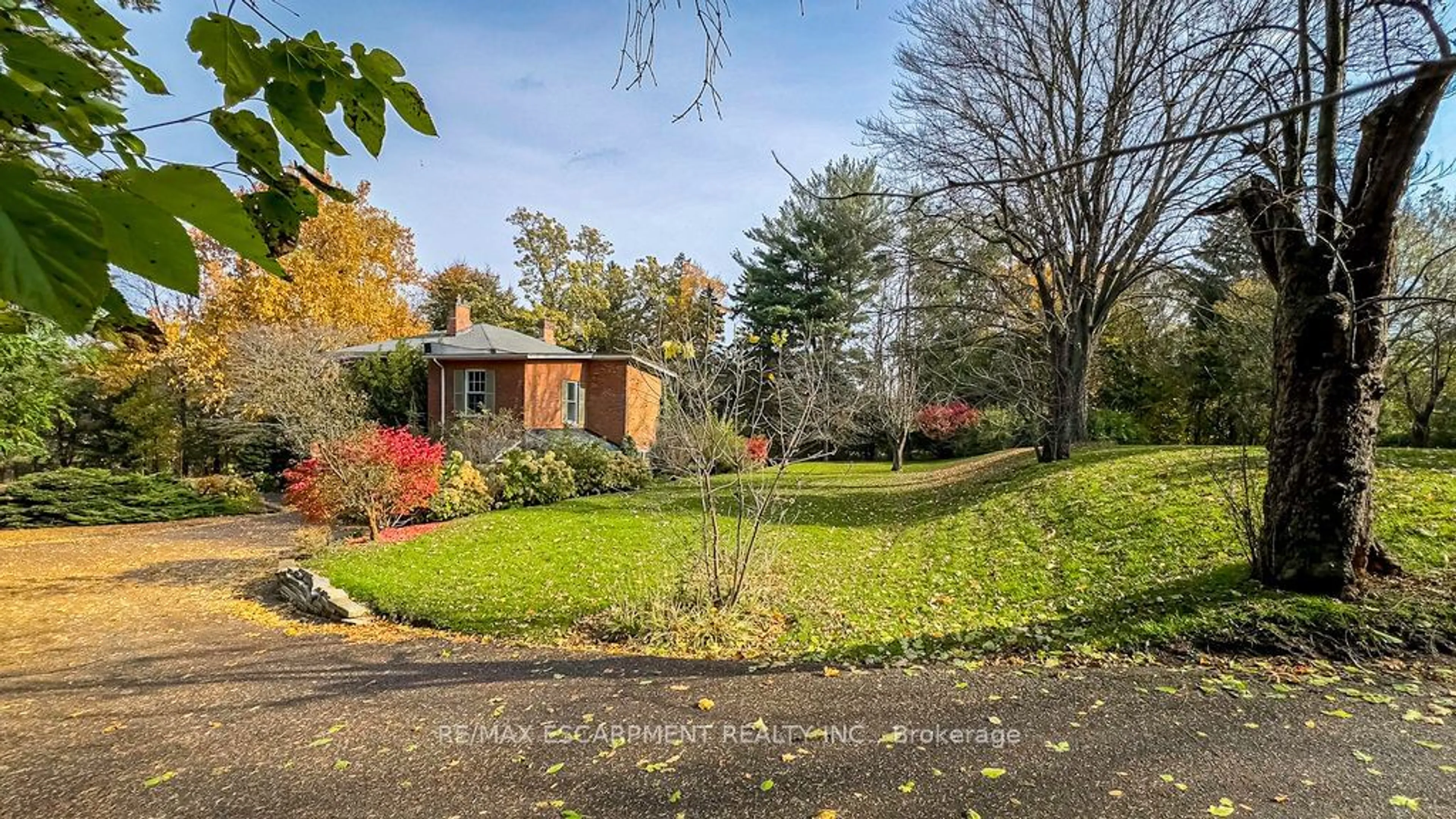 A pic from exterior of the house or condo, the fenced backyard for 30 South St, Hamilton Ontario L9H 4C5