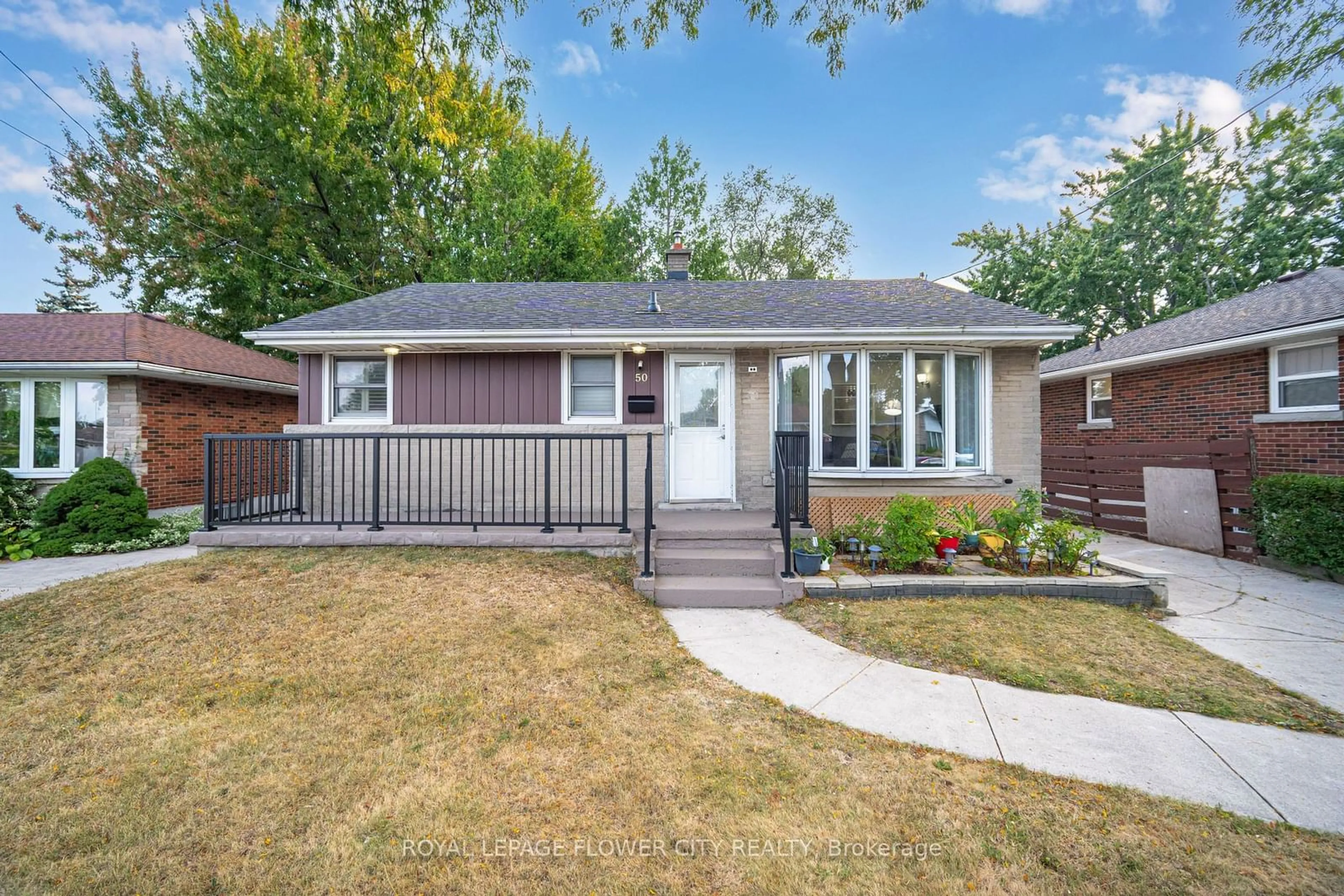 Frontside or backside of a home, the fenced backyard for 50 Beacon Ave, Hamilton Ontario L8T 2N5