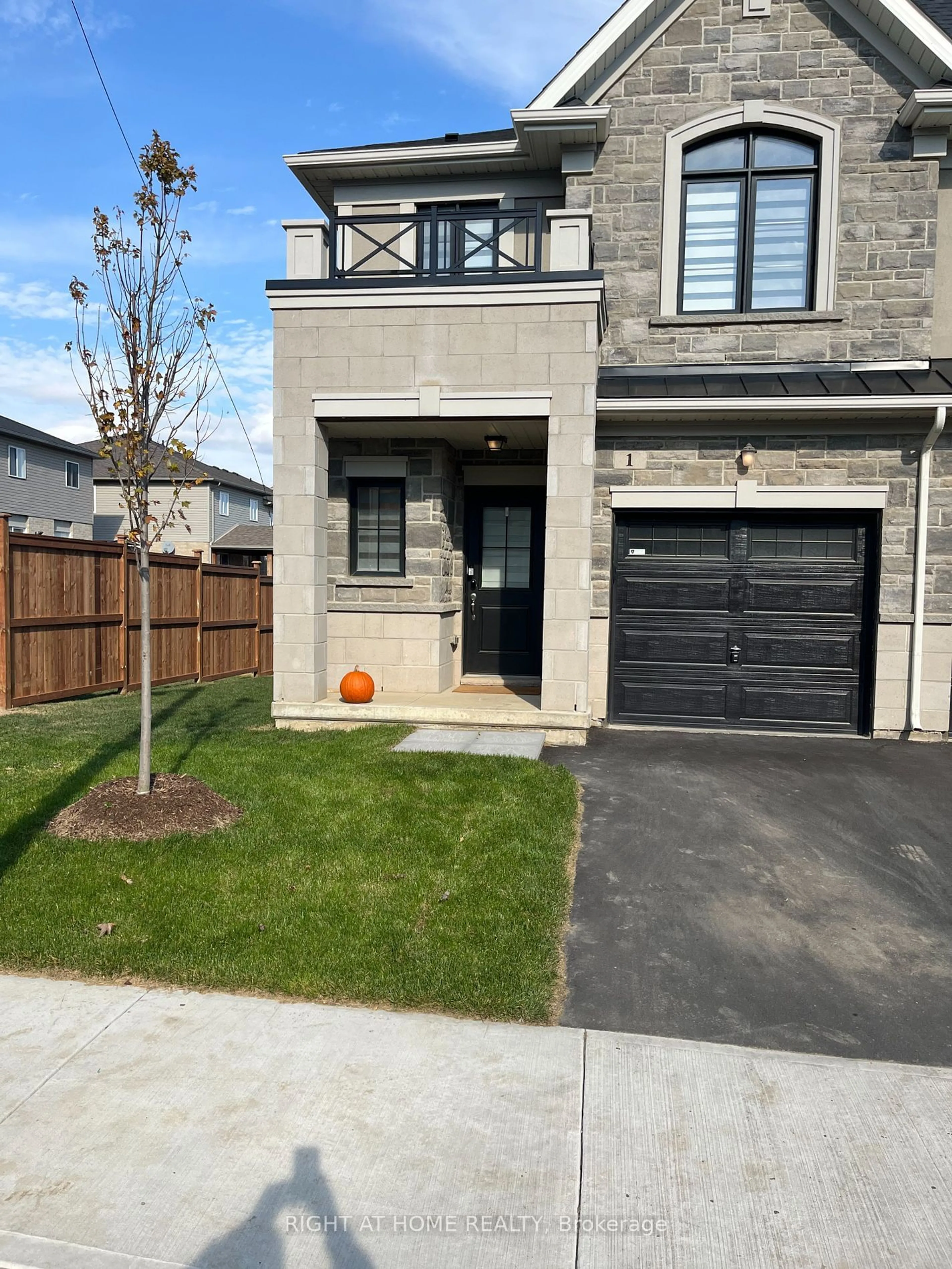 Frontside or backside of a home, the fenced backyard for 30 MIA Dr #1, Hamilton Ontario L9B 0K1