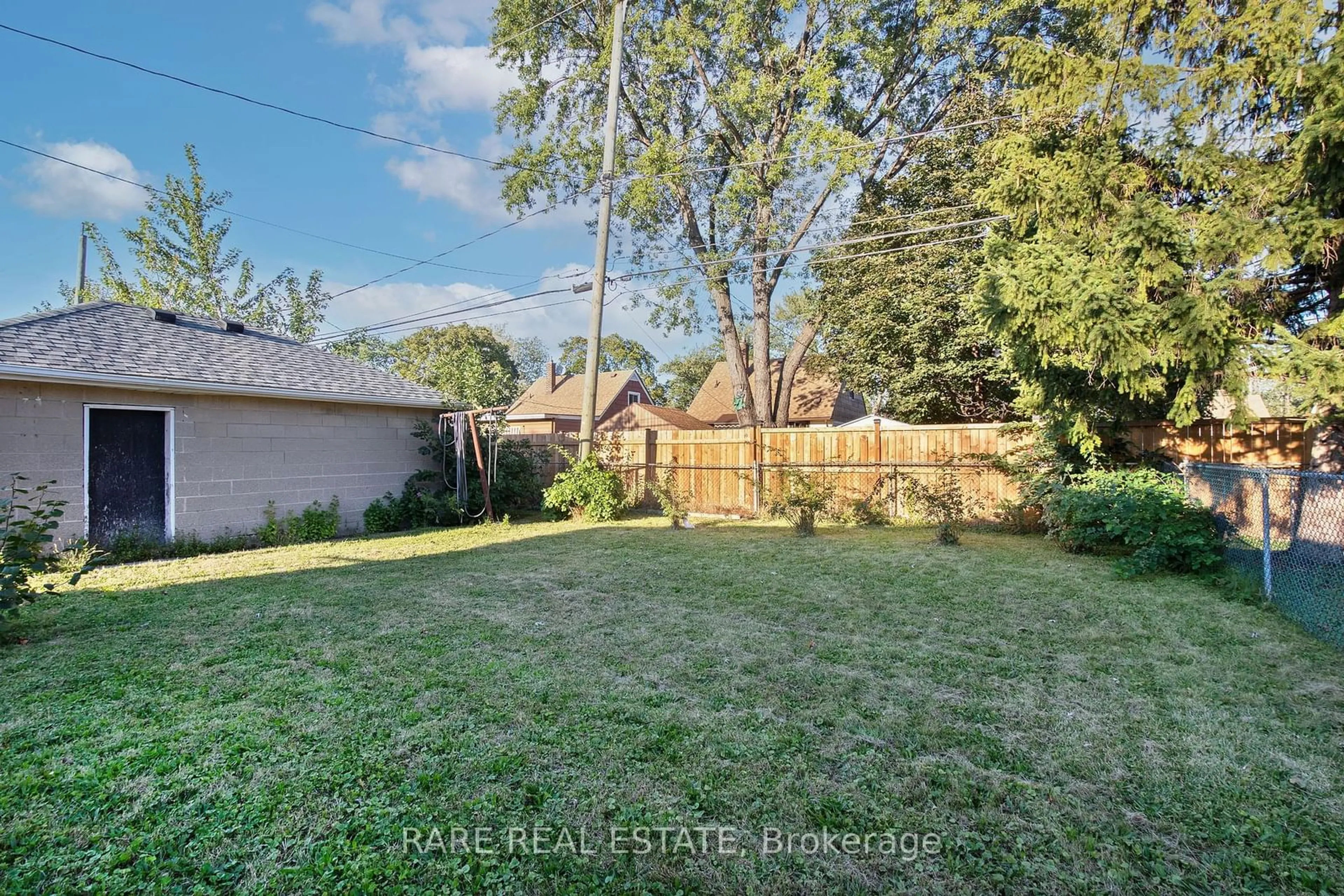 Frontside or backside of a home, the fenced backyard for 1544 Pillette Rd, Windsor Ontario N8Y 3C2