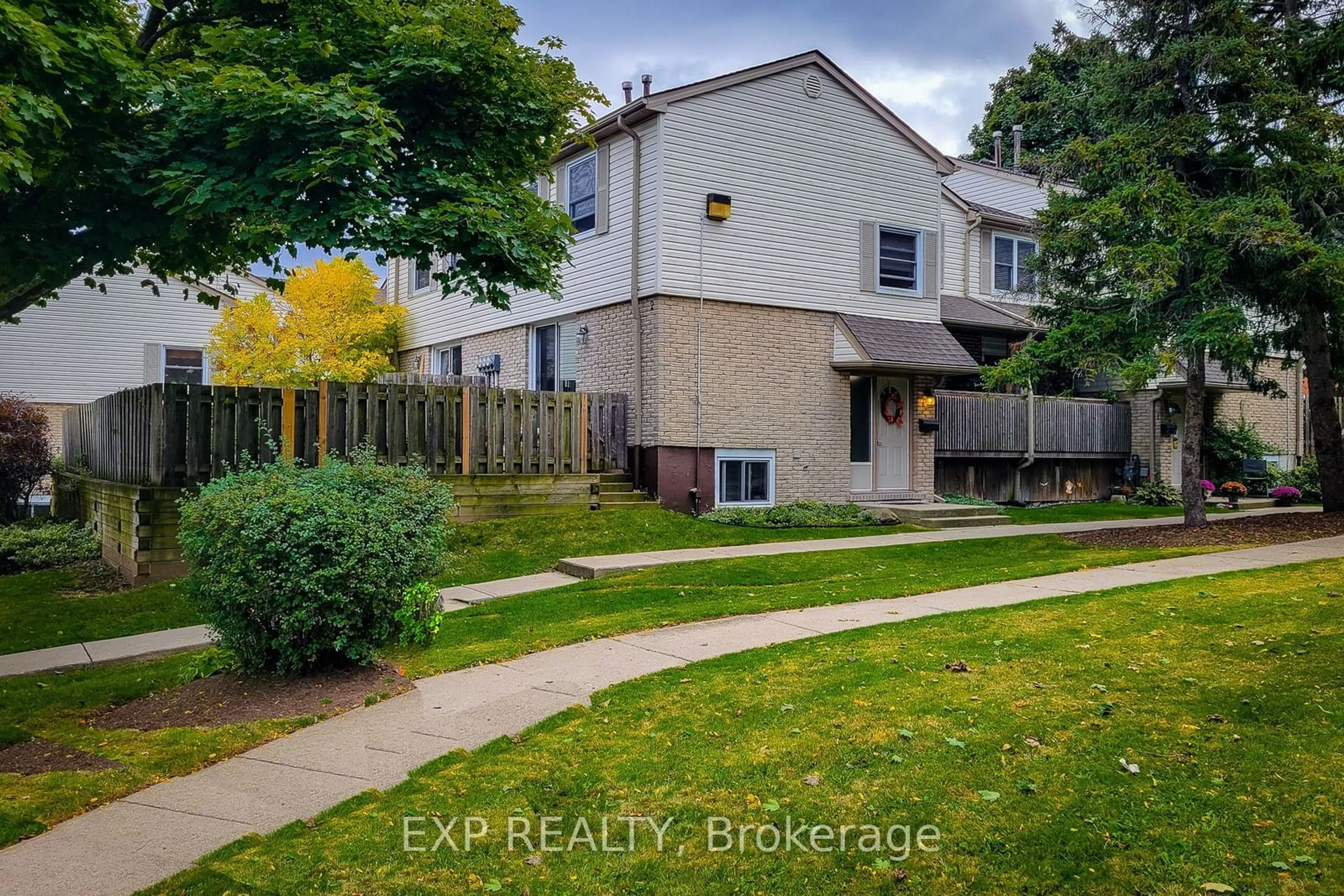 A pic from exterior of the house or condo, the fenced backyard for 1300 Upper Ottawa St #2, Hamilton Ontario L8W 1M8