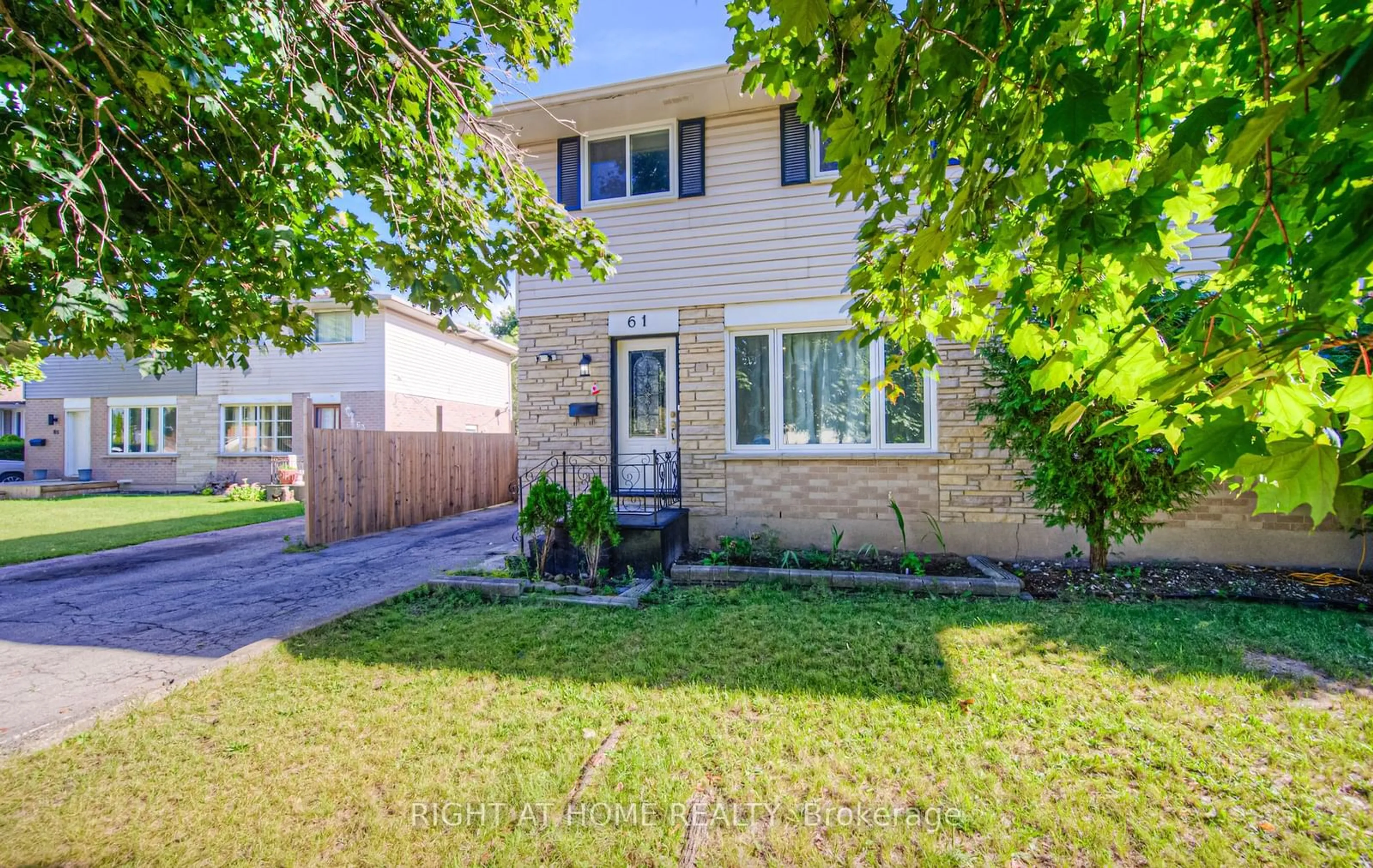 A pic from exterior of the house or condo, the fenced backyard for 61 Winter Ave, Cambridge Ontario N1R 5Z7