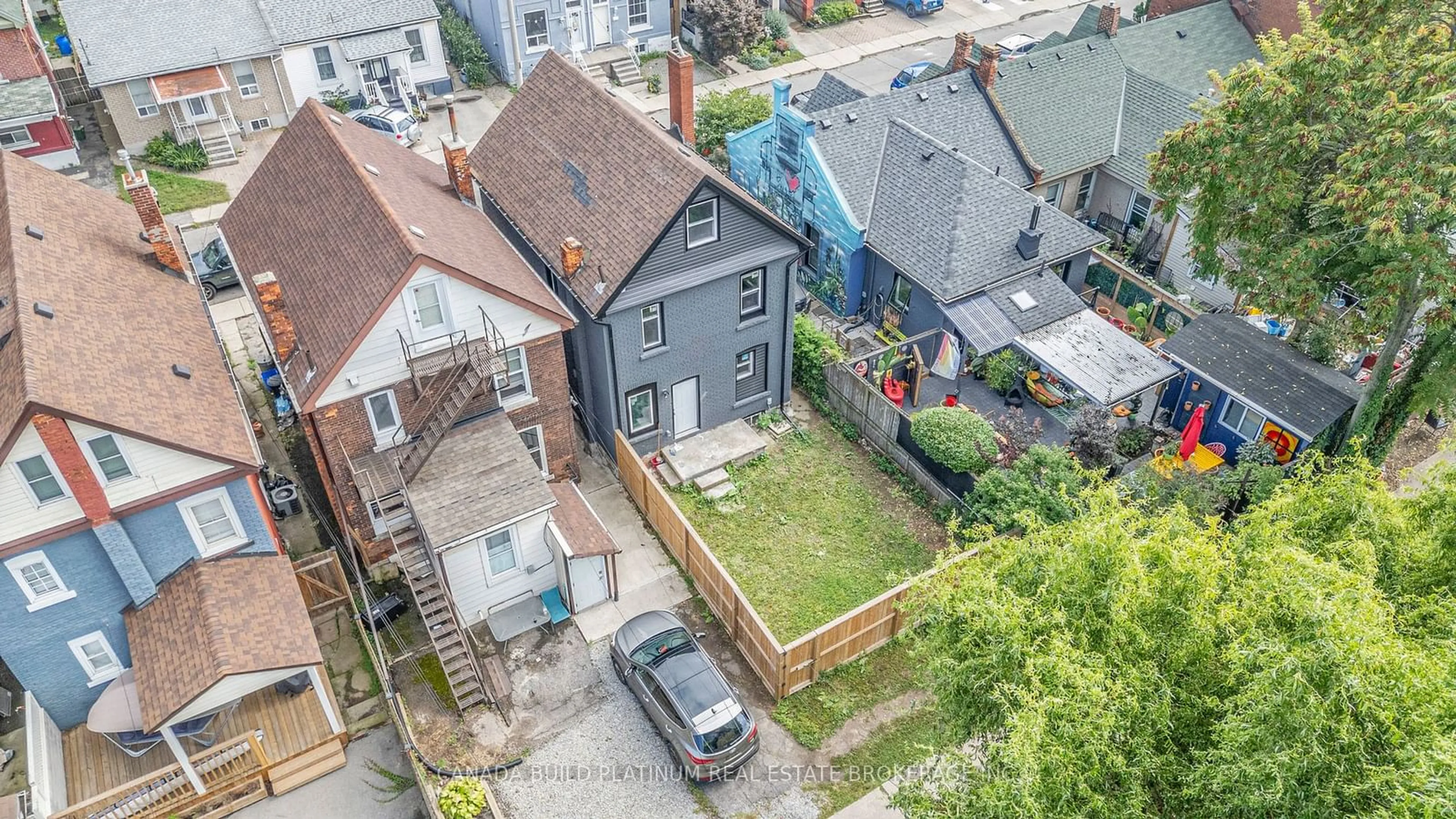 Frontside or backside of a home, the fenced backyard for 51 William St, Hamilton Ontario L8L 5T6