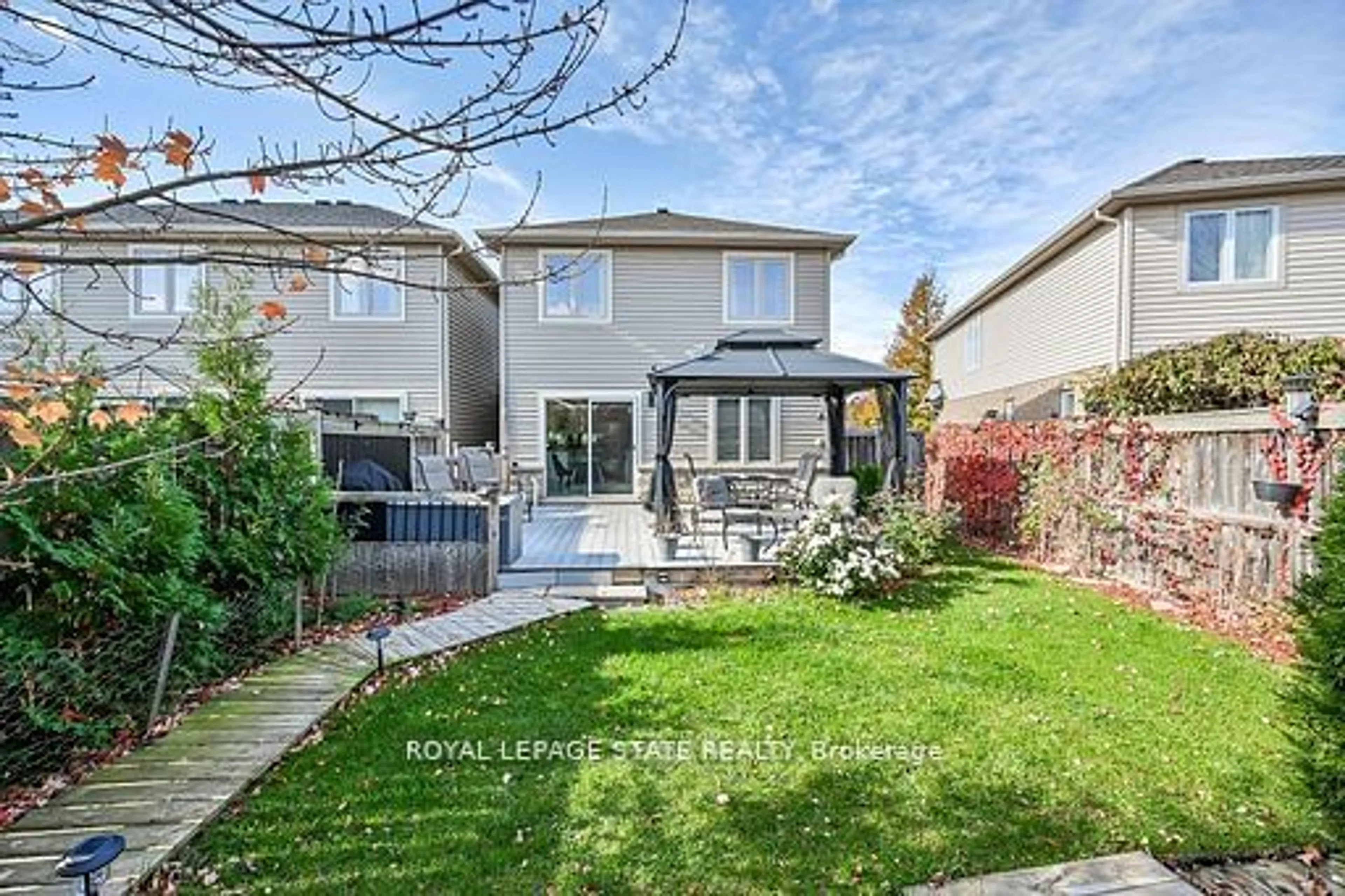 Frontside or backside of a home, the fenced backyard for 250 Fall Fair Way, Hamilton Ontario L0R 1C0