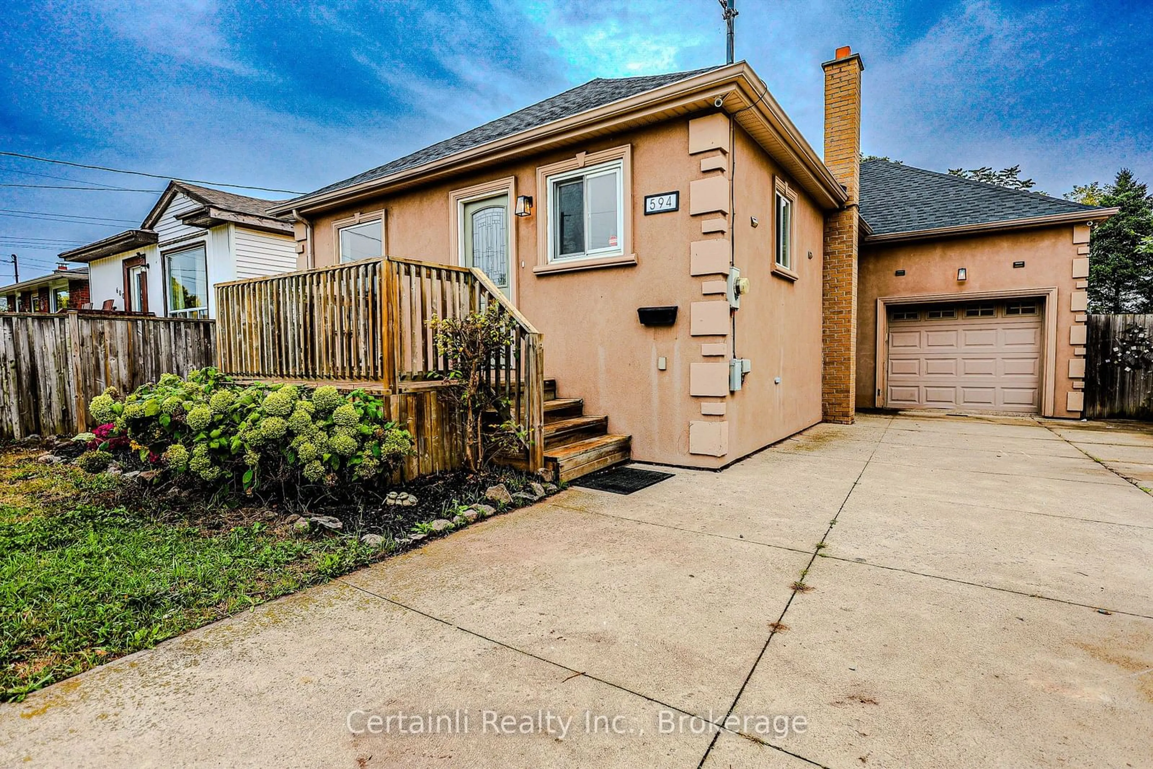 Frontside or backside of a home, the fenced backyard for 594 Waterloo St, Hamilton Ontario L8H 6V5