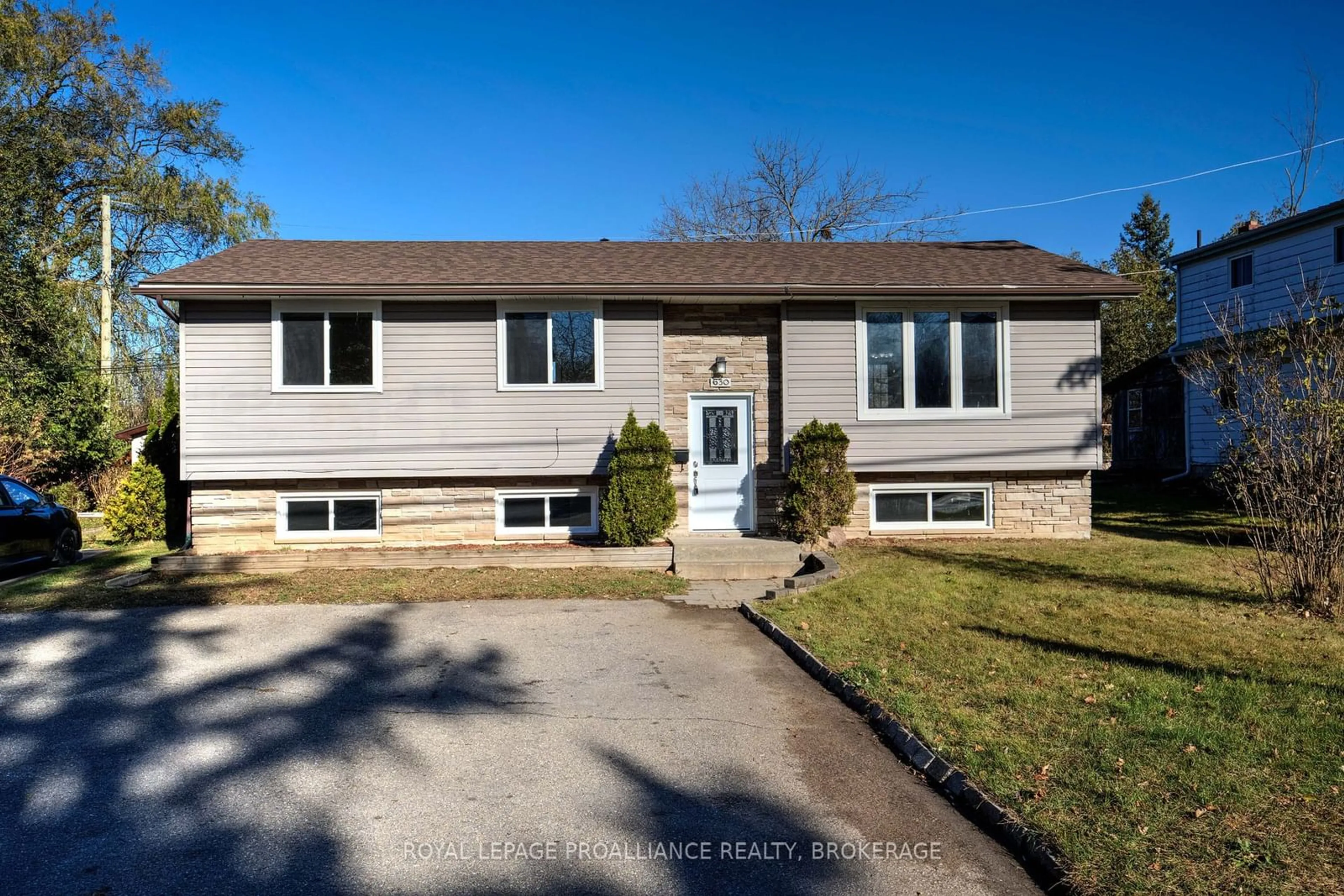 Frontside or backside of a home, the fenced backyard for 630 King St, Gananoque Ontario K7G 2H4