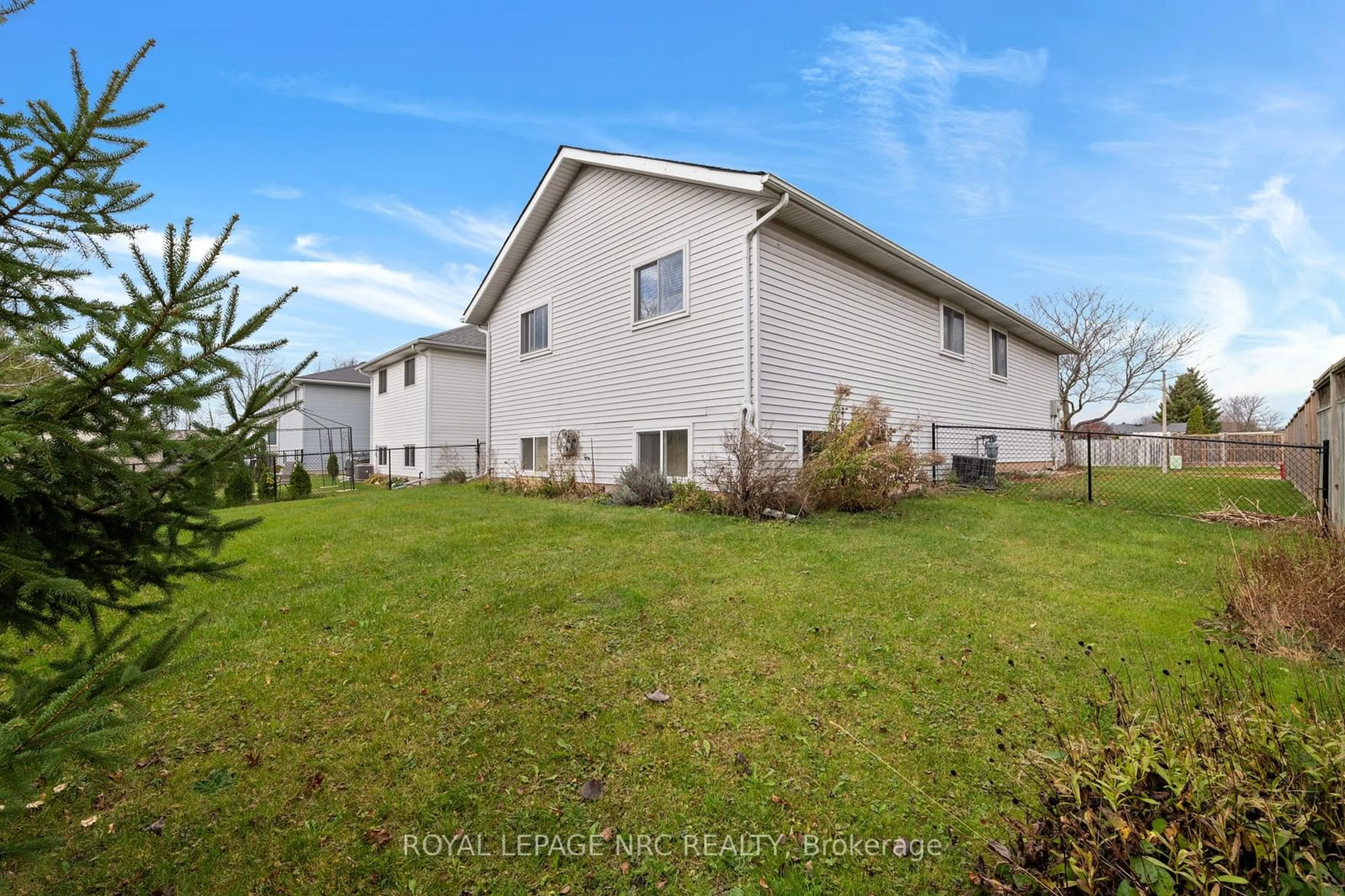 Frontside or backside of a home, the fenced backyard for 199 Balsam St, Welland Ontario L3C 7H1