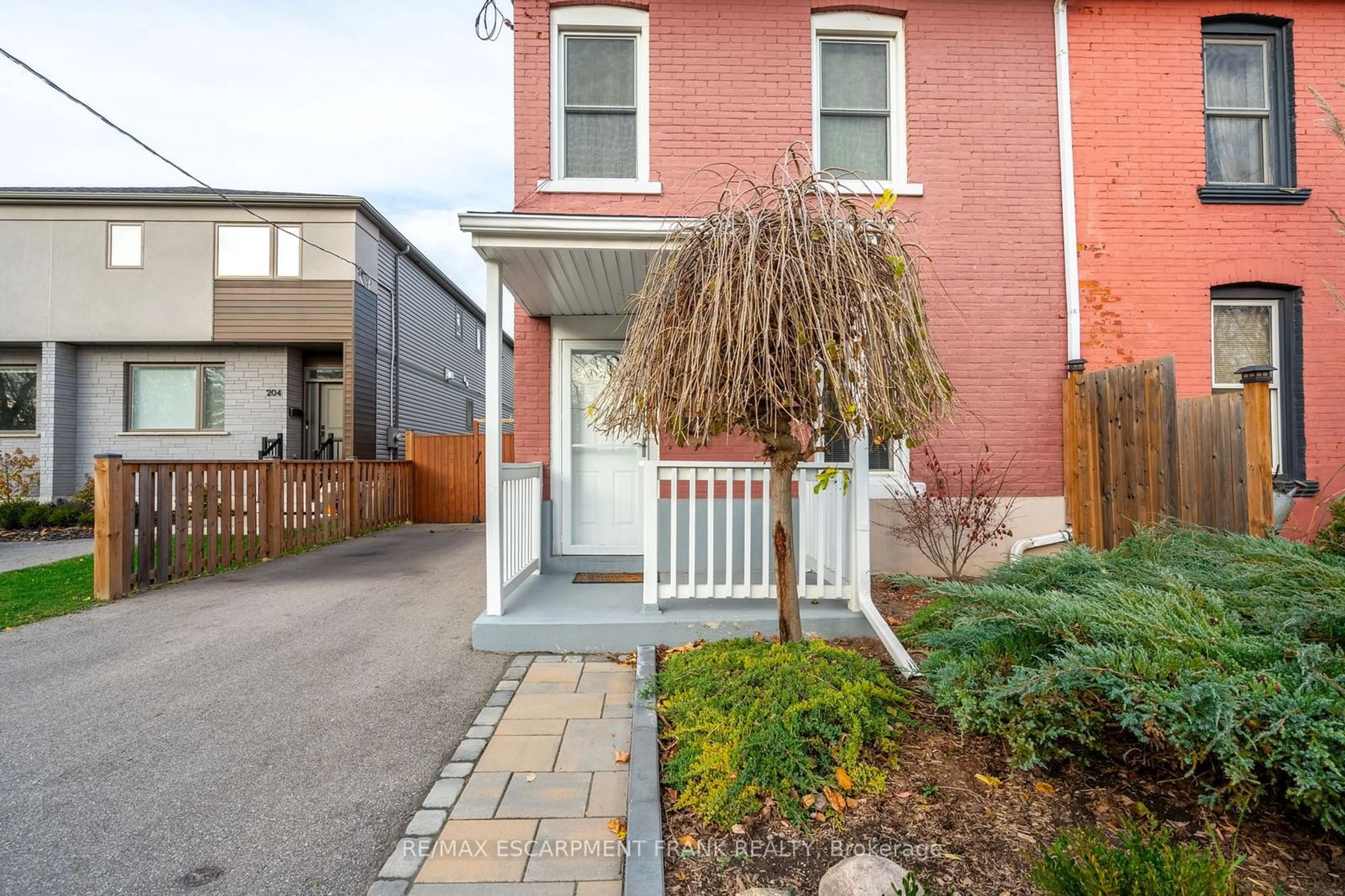 A pic from exterior of the house or condo, the fenced backyard for 202 CANADA St, Hamilton Ontario L8P 1P6