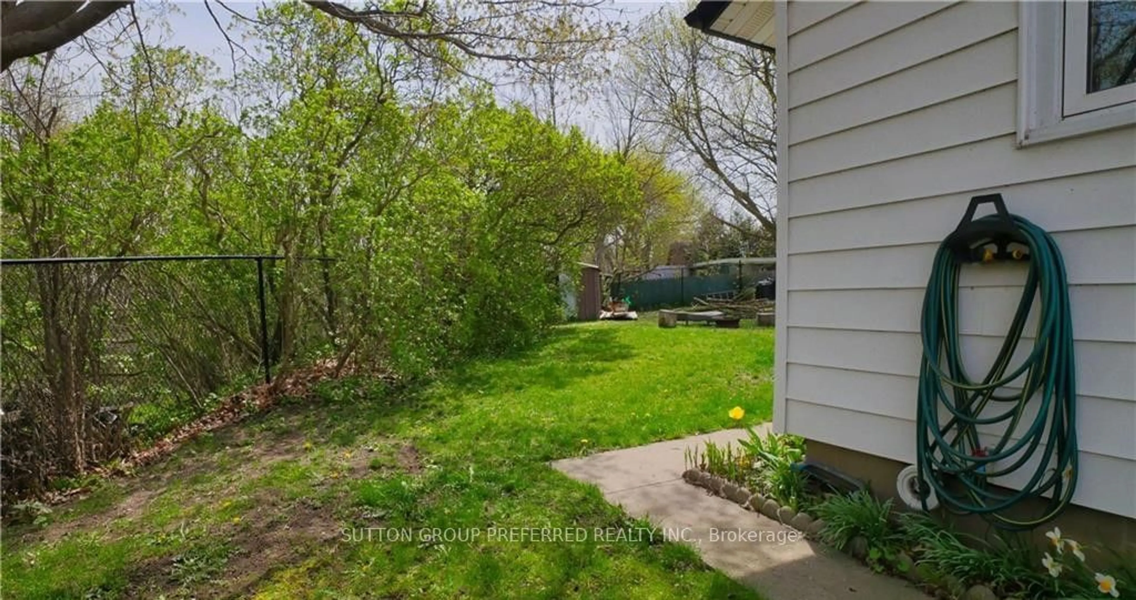 Frontside or backside of a home, the fenced backyard for 215 Charles St, Ingersoll Ontario N5C 2M4