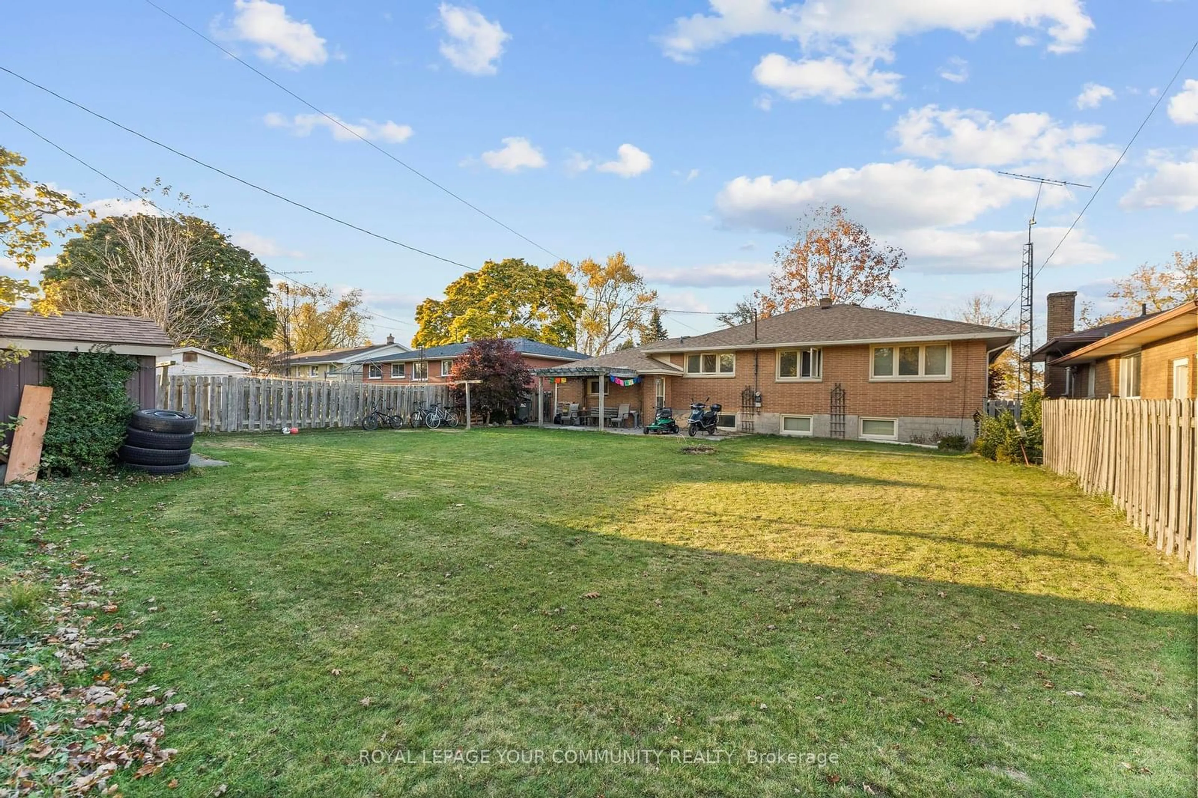 Frontside or backside of a home, the fenced backyard for 36 Pearl Ave, Leamington Ontario N8H 1J7