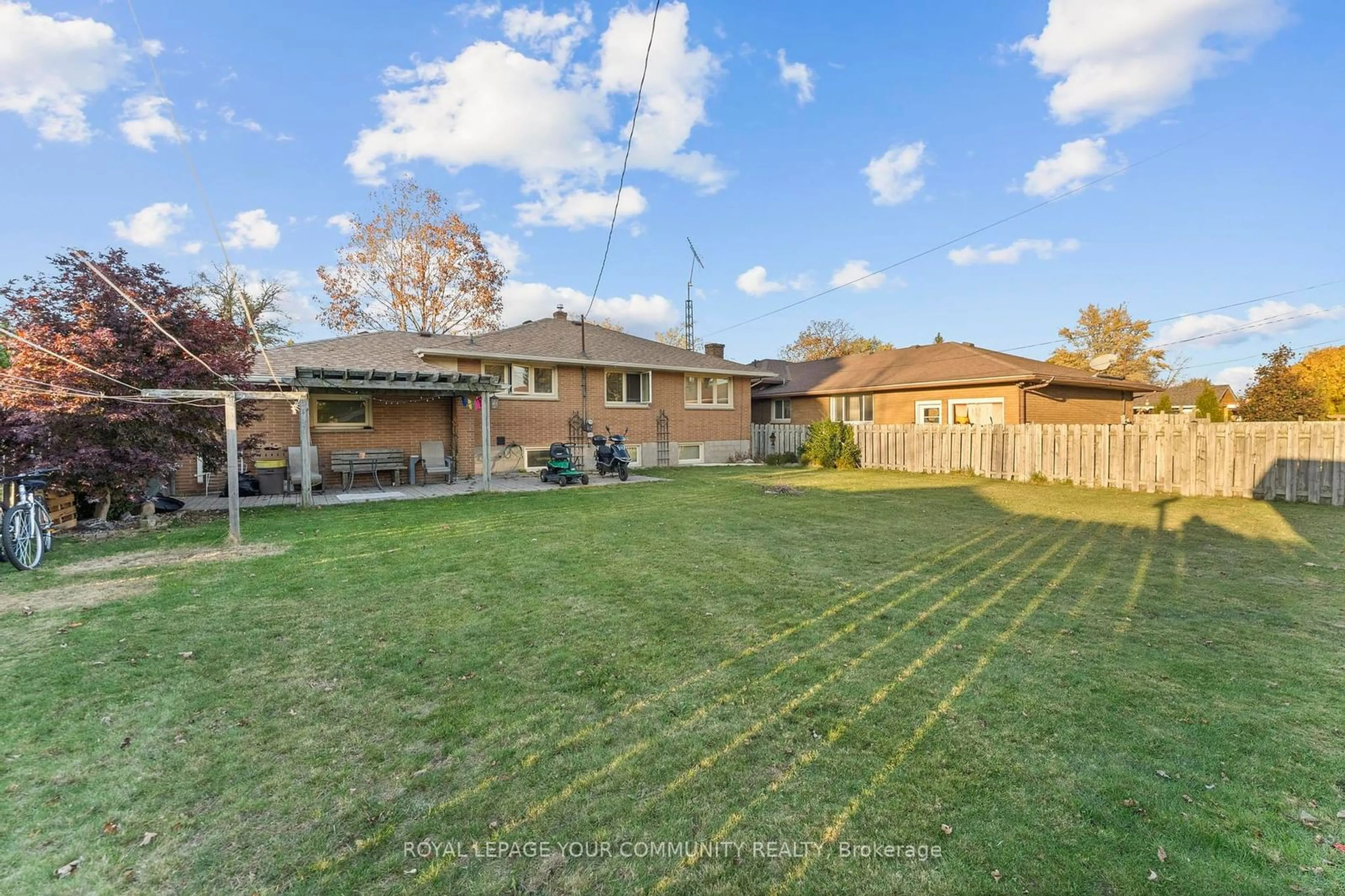 Frontside or backside of a home, the fenced backyard for 36 Pearl Ave, Leamington Ontario N8H 1J7