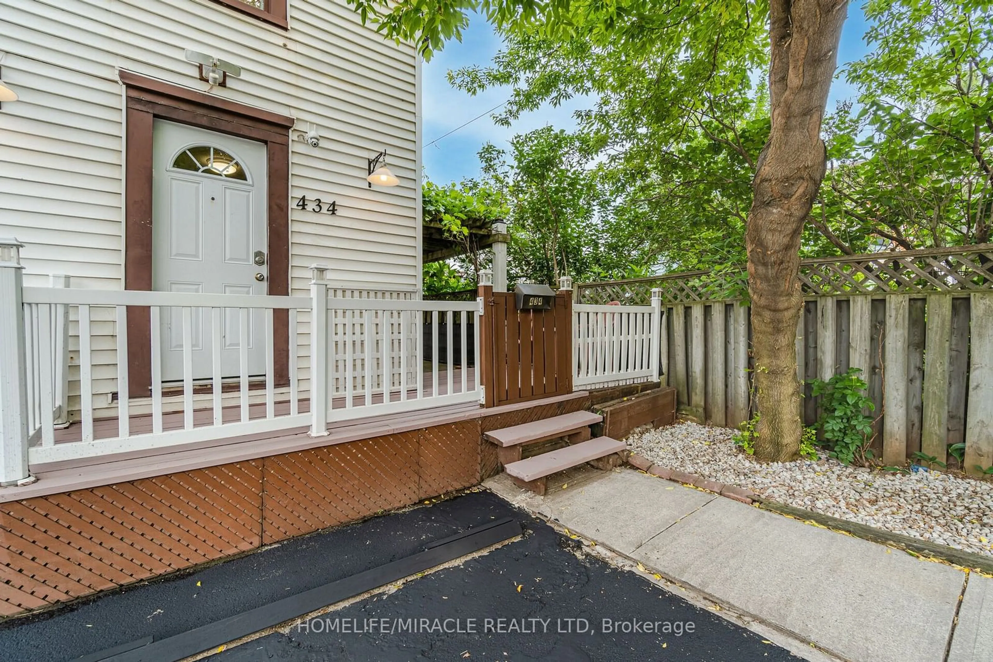 A pic from exterior of the house or condo, the fenced backyard for 434 Ferguson Ave, Hamilton Ontario L8L 4Y9