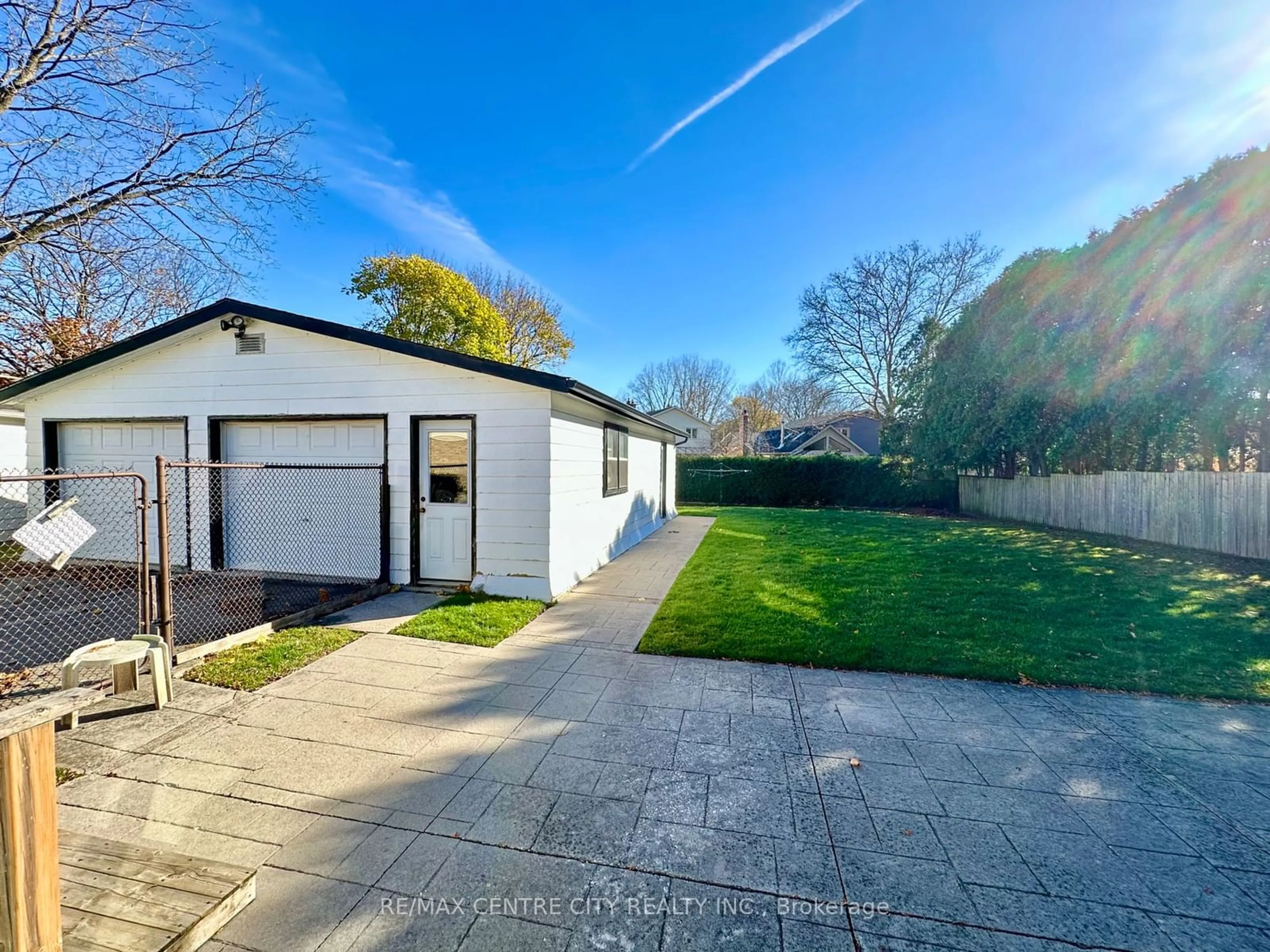 Frontside or backside of a home, the fenced backyard for 155 Meridene Cres, London Ontario N5X 1G3