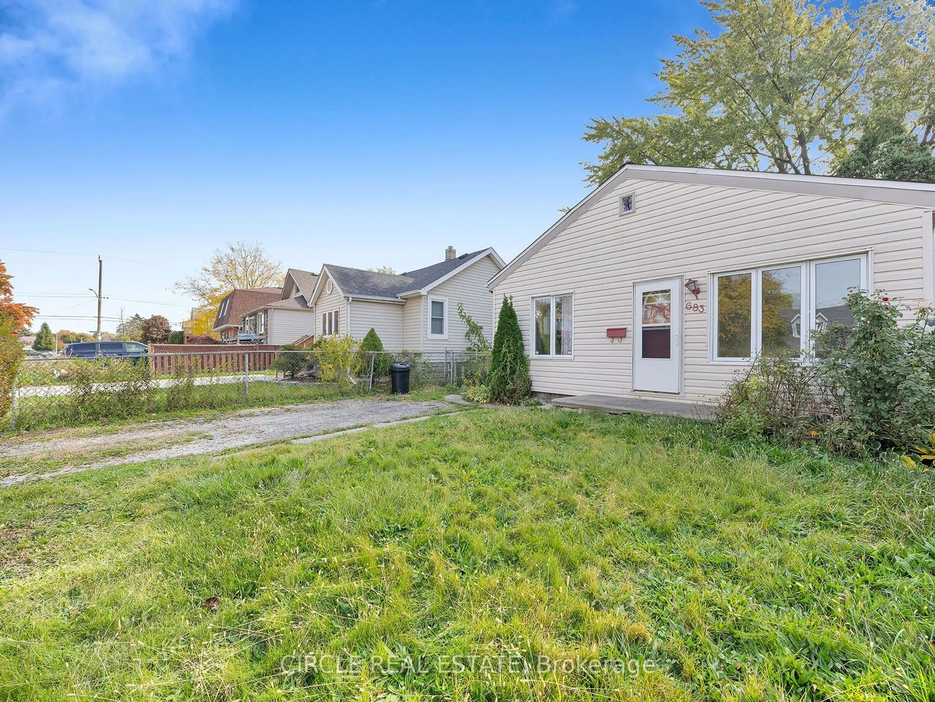 Frontside or backside of a home, the fenced backyard for 683 Stanley St, Windsor Ontario N8X 3B3