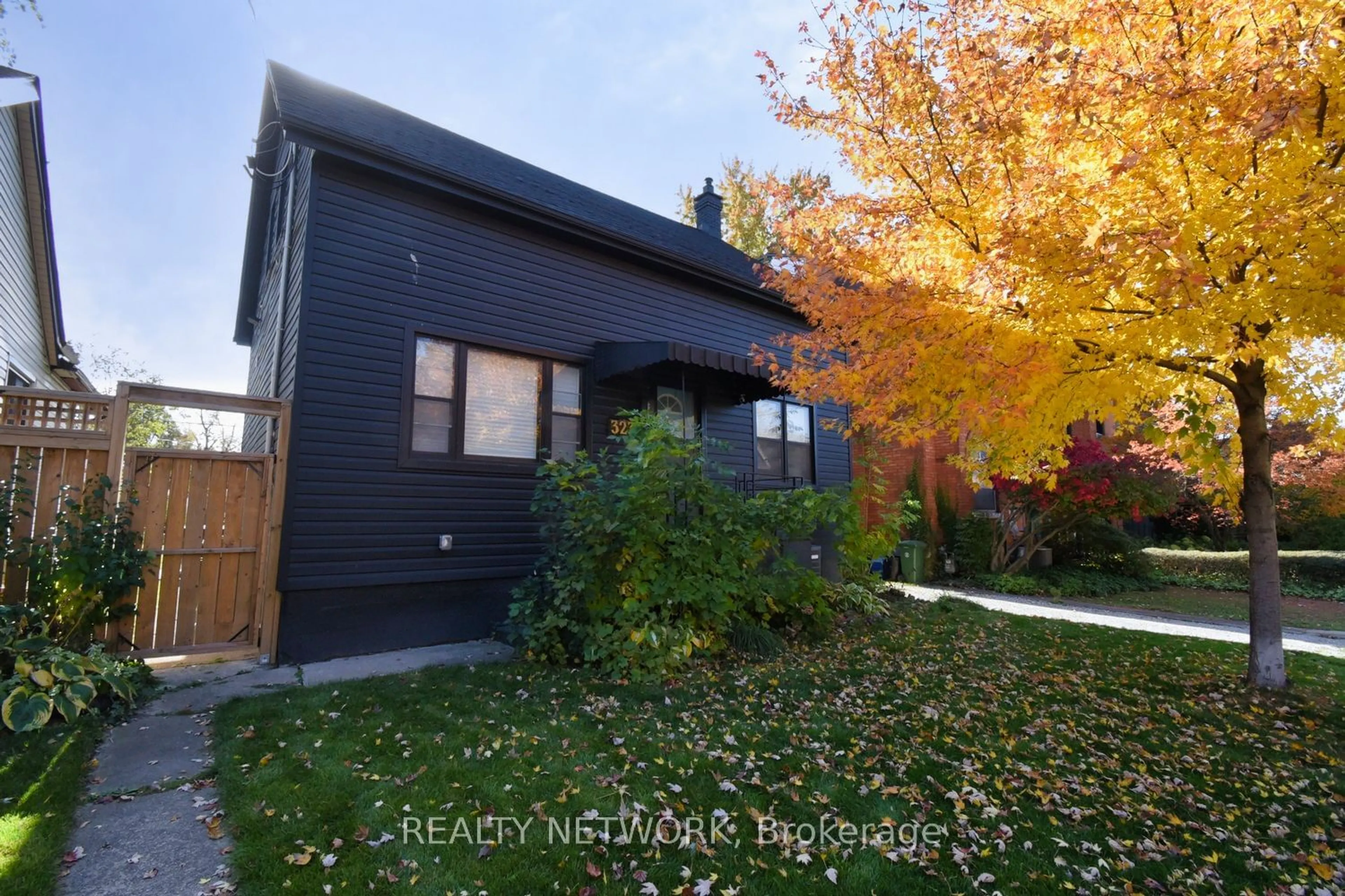 Frontside or backside of a home, the fenced backyard for 323 Charlton Ave, Hamilton Ontario L8L 4S9