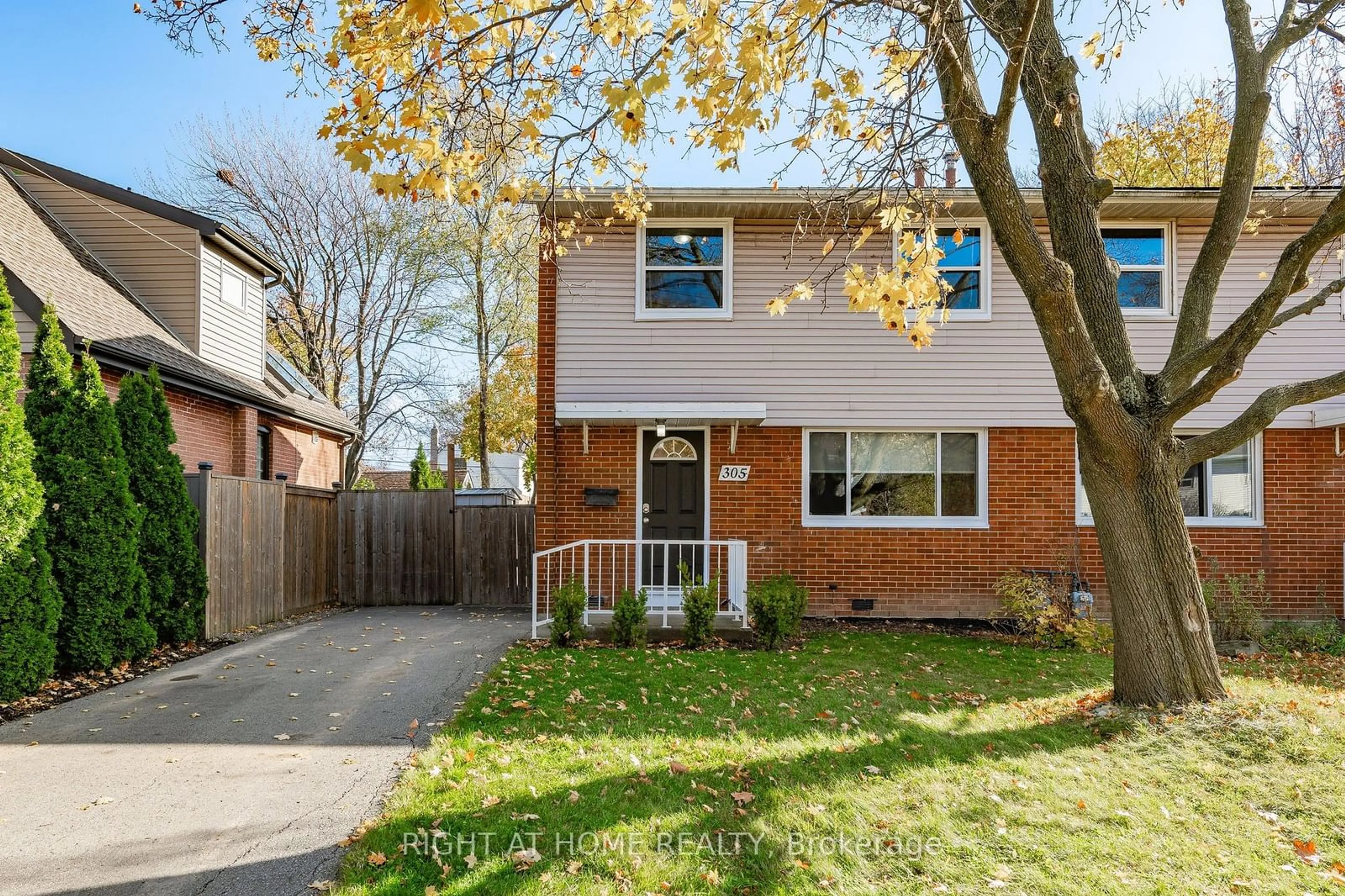 Frontside or backside of a home, the fenced backyard for 305 East 24th St, Hamilton Ontario L8V 2Y7