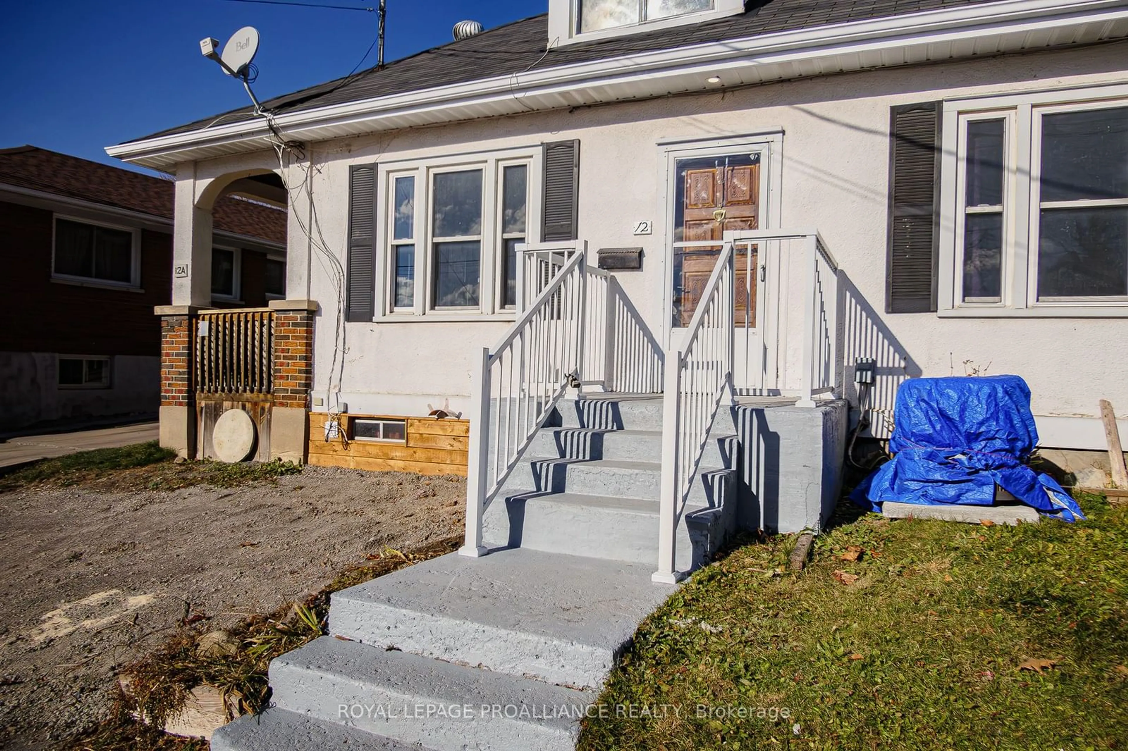 Frontside or backside of a home, the fenced backyard for 12 Richard St, Quinte West Ontario K8V 1V1